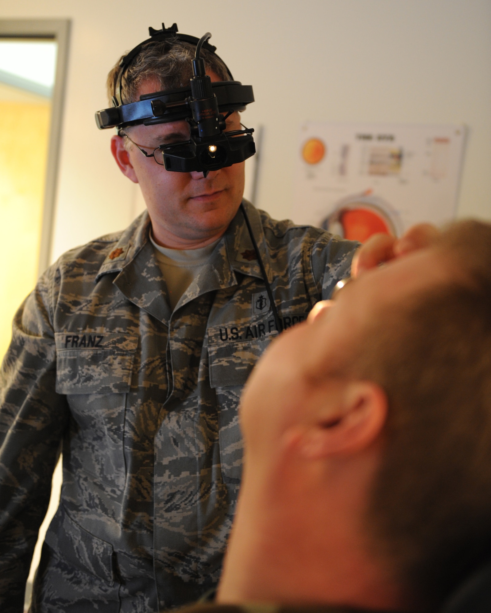 WHITEMAN AIR FORCE BASE, Mo. - Maj. Doug Franz, 509th Medical Operations Squadron optometrist, uses a binocular in-direct ophthalmoscope to look into a patient’s retina for eye disease Jan. 12. Dr. Franz wears the device on his head which aligns a microscope in front of his eyes allowing him to look into the lens he holds over the patients’ eye and direct light into the retina. The optometry clinic serves active duty and dependents and is open Monday – Thursday from 7:30 a.m. – 4:30 p.m. and Friday from 8:30 a.m. – 4:30 p.m. Appointments can be made by calling 687-2188. (U.S. Air Force photo/Airman 1st Class Carlin Leslie)