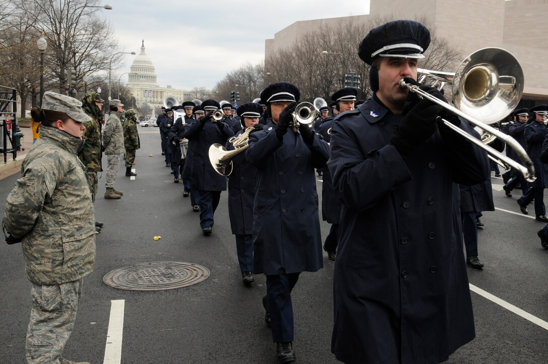 Members of the United States Air Force Band march down Constitution Avenue as Airmen from the Air Force District of Washington stand in a cordon Jan. 11 in Washington during a practice run of the inauguration parade for President-elect Barack Obama. (U.S. Air Force photo by Staff Sgt. Dan DeCook)