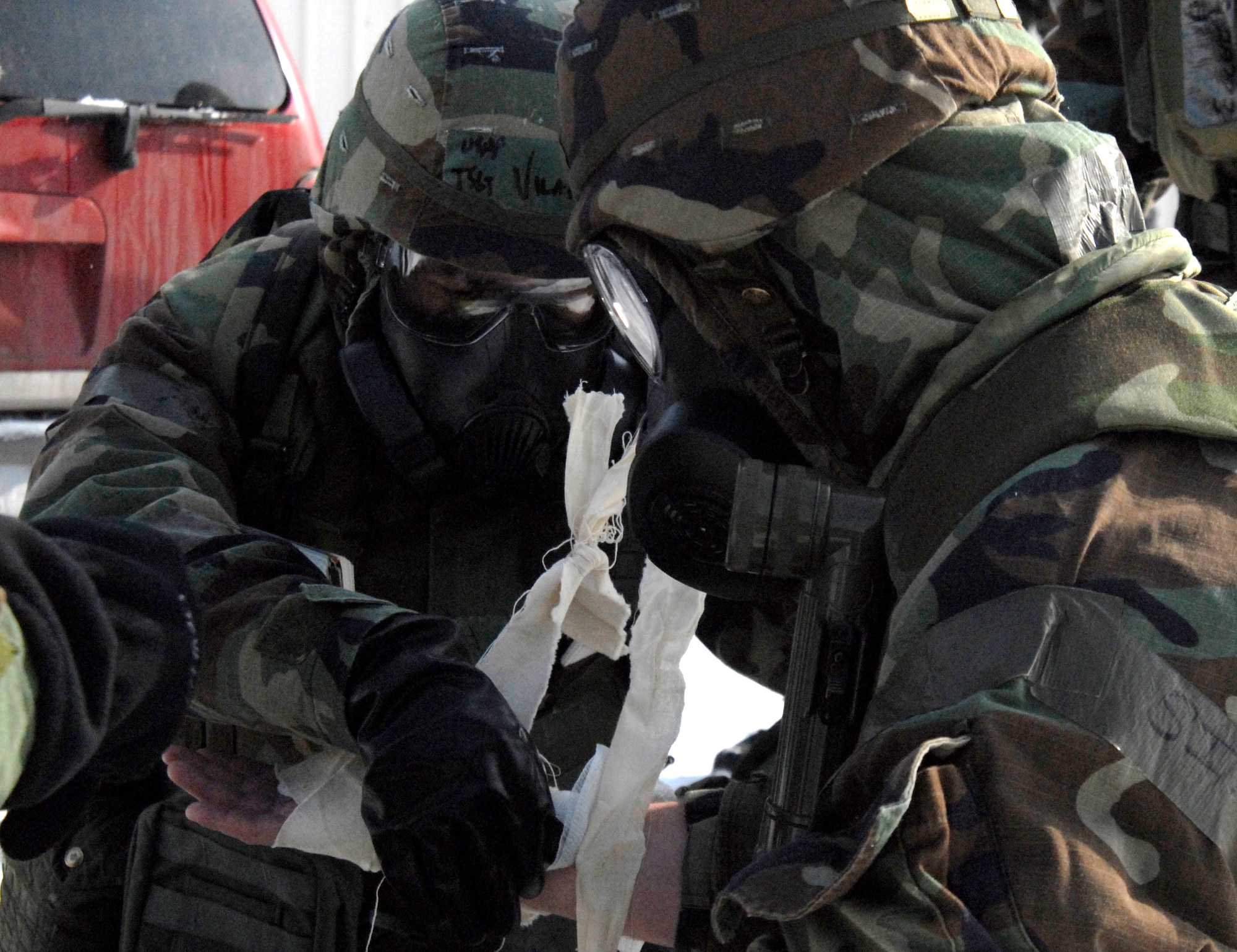 An Airman at Kunsan Air Base administer first aid and buddy care to a fire victim while Fire Fighters respond to the fire during the Peninsula Wide Operation Readiness Exercise at Kunsan Air Base, Republic of Korea, Jan. 13, 2009. (U.S. Air Force Photo by SSgt Jason Colbert)