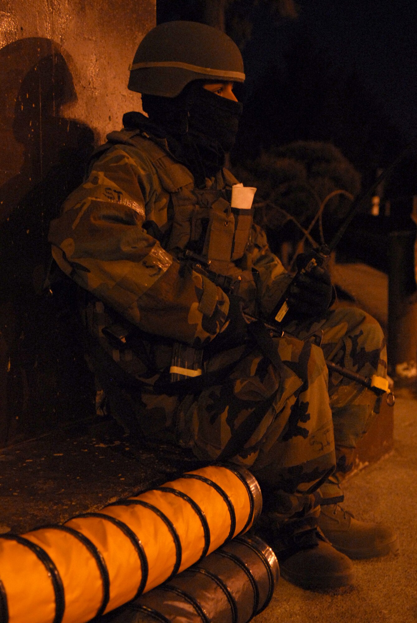 Senior Airman Daniel Rivera uses hoses connected to a heating unit to stay warm, while providing security at a defensive fighting position during Exercise Beverly Bulldog 09-01 Jan. 13. The 51st Fighter Wing is currently undergoing a week-long Operational Readiness Exercise to test its ability to conduct war time missions. Airman Rivera is assigned to the 51st Security Forces Squadron U.S. Air Force photo/Senior Airman Christopher Boitz)