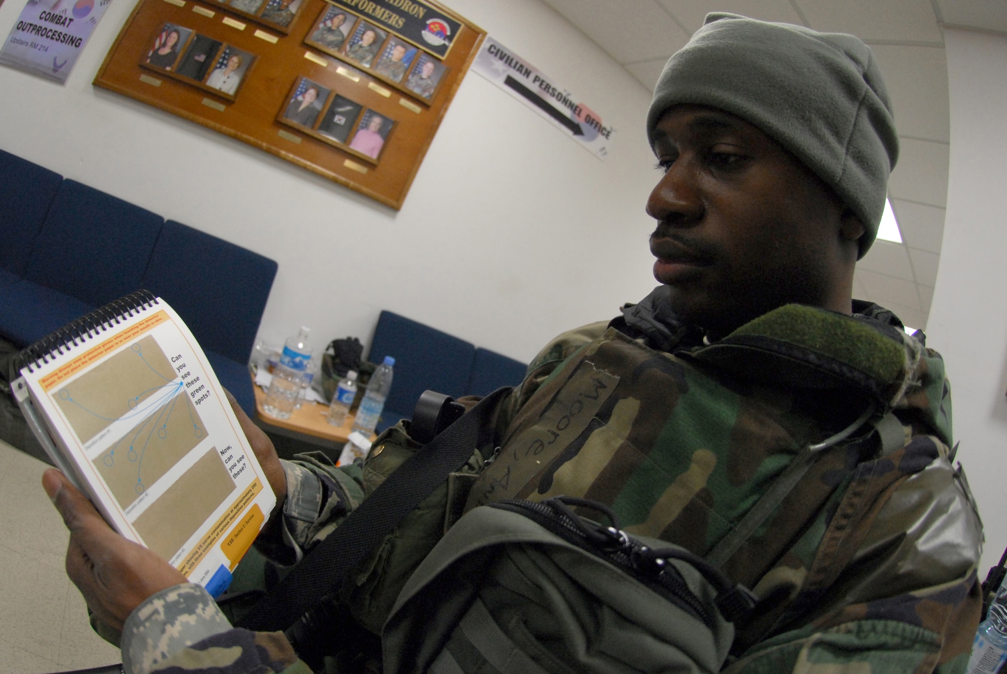 Tech Sgt. Andre Moore reviews how to detect contamination on M8 paper in his Airman's Manual during Exercise Beverly Bulldog 09-01 at Osan AB Jan. 13. The 51st Fighter Wing is currently undergoing a week-long Operational Readiness Exercise to test its ability to conduct war time missions.  Sergeant Moore is assigned to the 51st Mission Support squadron. (U.S. Air Force photo/Senior Airman Christopher Boitz)