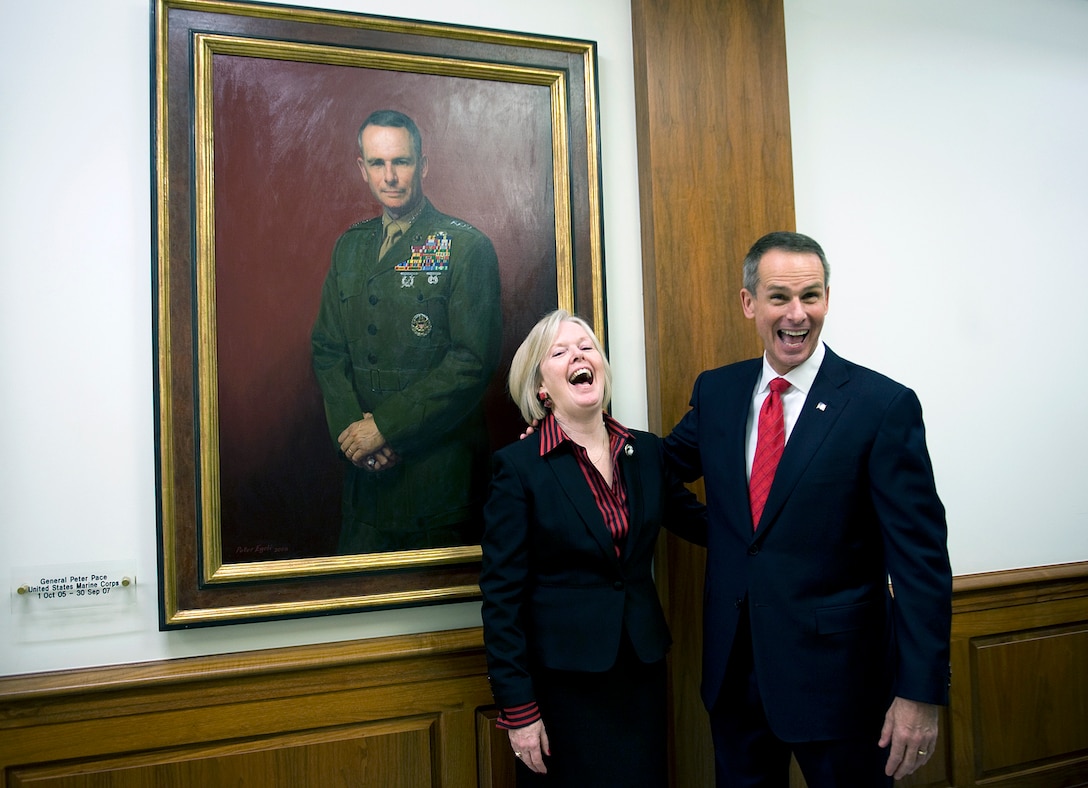 Retired U.S. Marine Gen. Peter Pace, 16th chairman of the Joint Chiefs, and his wife Lynne pose for photos after the hanging of his portrait in the chairmans' corridor at the Pentagon, Jan. 13, 2009.