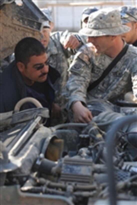 U.S. Army Chief Warrant Officer Jason Barrett from Foxtrot Company, 2nd Battalion, 505th Parachute Infantry Regiment, 3rd Brigade Combat Team, 82nd Airborne Division explains the mechanical systems of a Humvee to Iraqi National Police mechanics during Humvee familiarization training at Joint Security Station Beladiyat in Baghdad, Iraq, on Jan. 5, 2009.  