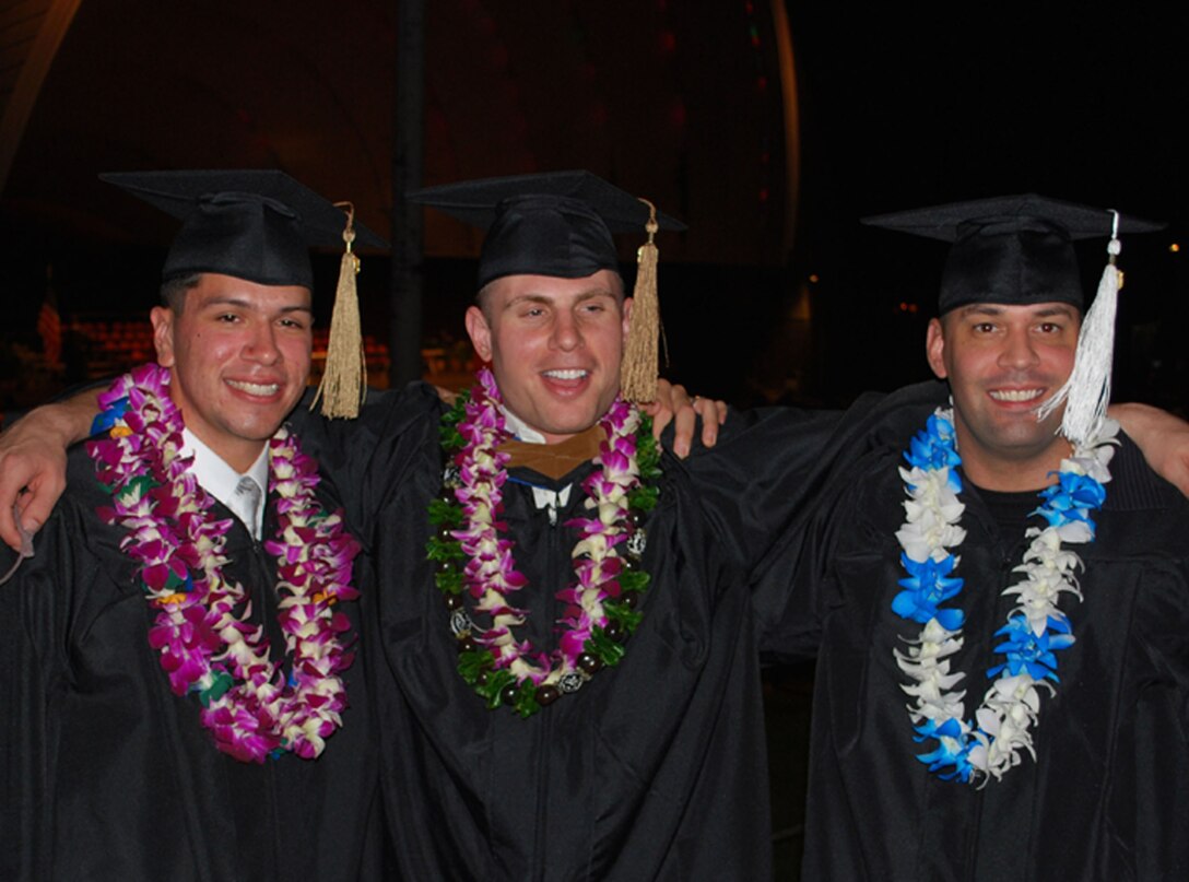 (From left to right) Sgts. Mitchell Oshkeshequoam, Jake Isberner and Wayne Welty, U.S. Marine Corps Forces, Pacific command security branch noncommissioned officers walked across the stage at the Waikiki Shell here Jan. 14 to receive their diplomas from Hawaii Pacific University. The Marines planned for this event three years ago, when they decided they would motivate each other to achieve their goals together. Oshkeshequoam earned a bachelor's degree in business administration, Welty earned a bachelor's degree in justice administration and Isberner earned his second degree, a master's degree in business administration.