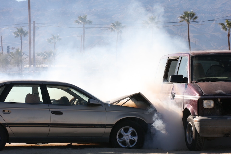 Smoke erupts from the front end of a crashed vehicle, while a victim rests motionless against the steering wheel during a mock car accident at the Combat Center’s Victory Field Jan. 24, 2009. The accident was part of a skit put on by the Safety Office here as part of the Fiscal Year 2009 Post Holiday Back in the Saddle Stand Down. The Safety Office, in a joint effort with the Combat Center Fire Department, PMO and the Inspector General, performed the skit to raise awareness about the dangers of drunk driving.