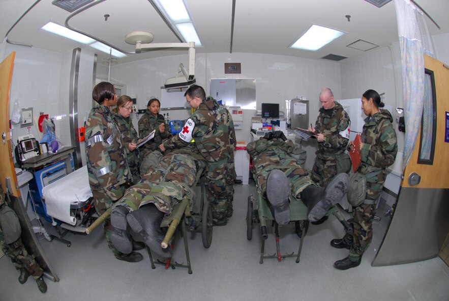 Airmen assigned to the 51st Medical Group conduct assessments of two exercise patients at the hospital emergency room during Exercise Beverly Bulldog 09-01 Jan. 14 at Osan AB. The 51st Fighter Wing is currently undergoing a week-long Operational Readiness Exercise to test its ability to conduct war time missions.  (U.S. Air Force photo/Senior Airman Christopher Boitz)