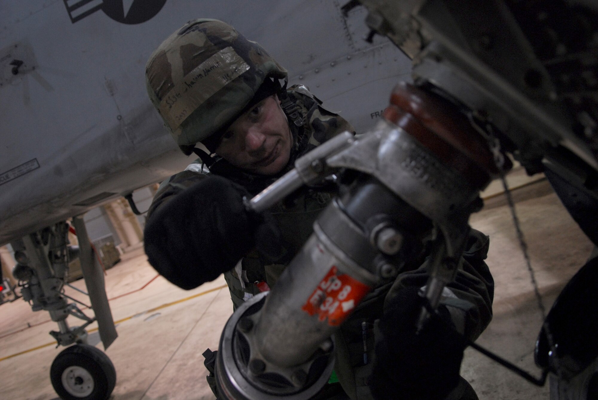Staff Sgt. Shawn Harris attaches a fuel hose an A-10 Thunderbolt II during Exercise Beverly Bulldog 09-01 Jan. 14 at Osan AB. The 51st Fighter Wing is currently undergoing a week-long Operational Readiness Exercise to test its ability to conduct war time missions. Sergeant Harris is assigned to the 25th Aircraft Maintenance Unit. (U.S. Air Force photo/Senior Airman Christopher Boitz)