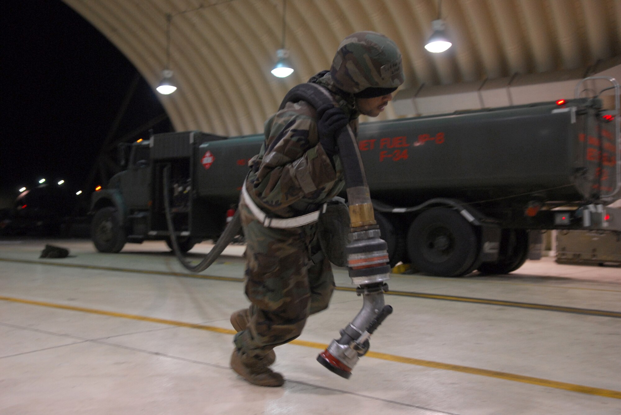 Senior Airman James Fox drags a fuel hose from his truck to an A-10 Thunderbolt II during Exercise Beverly Bulldog 09-01 Jan. 14 at Osan AB. The 51st Fighter Wing is currently undergoing a week-long Operational Readiness Exercise to test its ability to conduct war time missions. Senior Airman Fox is assigned to the 51st Logistics Readiness Squadron. (U.S. Air Force photo/ Senior Airman Christopher Boitz)