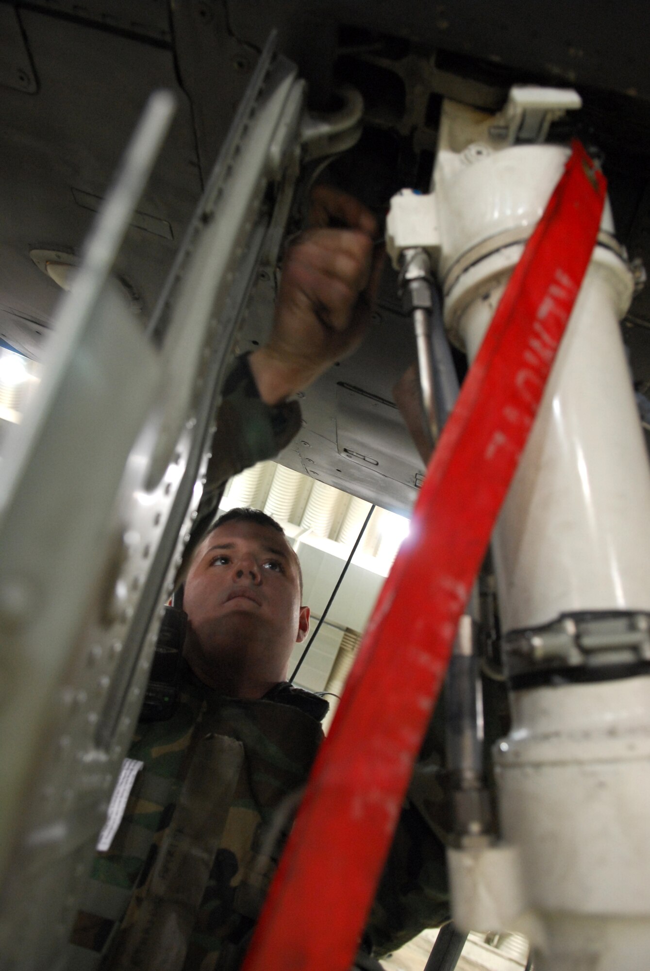 Staff Sgt. Patrick Ethridge tightens up bolts on the landing gear of an A-10 Thunderbolt II during Exercise Beverly Bulldog 09-01 Jan. 14 at Osan AB. The 51st Fighter Wing is currently undergoing a week-long Operational Readiness Exercise to test its ability to conduct war time missions. Sergeant Ethridge is assigned to the 25th Aircraft Maintenance Unit. (U.S. Air Force photo/Senior Airman Christopher Boitz)
