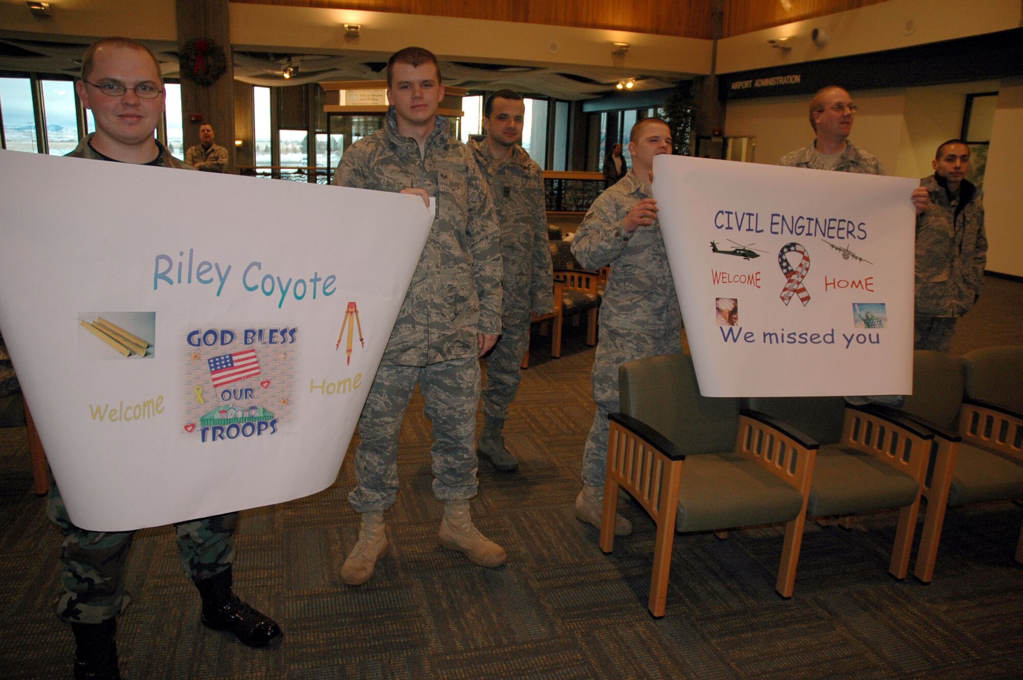 Members of the 341st Civil Engineer Squadron wait for the arrival of their co-workers at the Great Falls International Airport. Twenty-five of the 50 members from the 341st CES currently deployed returned home Jan. 7. (U.S. Air Force photo/Senior Airman Dillon White)