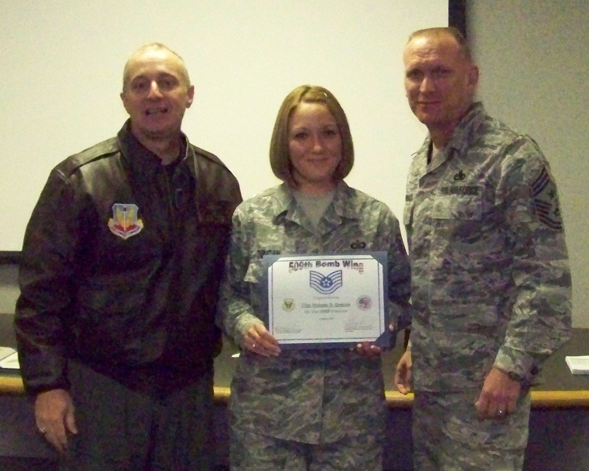 WHITEMAN AIR FORCE BASE, Mo. - Brig. Gen. Garrett Harencak (left), 509th Bomb Wing commander, Chief Master Sgt. Brian Hornback (right), 509th Bomb Wing command chief and Staff Sgt. Melanie Duncan, 509th Operations Group pose after Sergeant Duncan receives her Stripes for Exceptional Performers promotion to technical sergeant Jan. 6. (U.S. Air Force photo/Airman 1st Class Carlin Leslie)