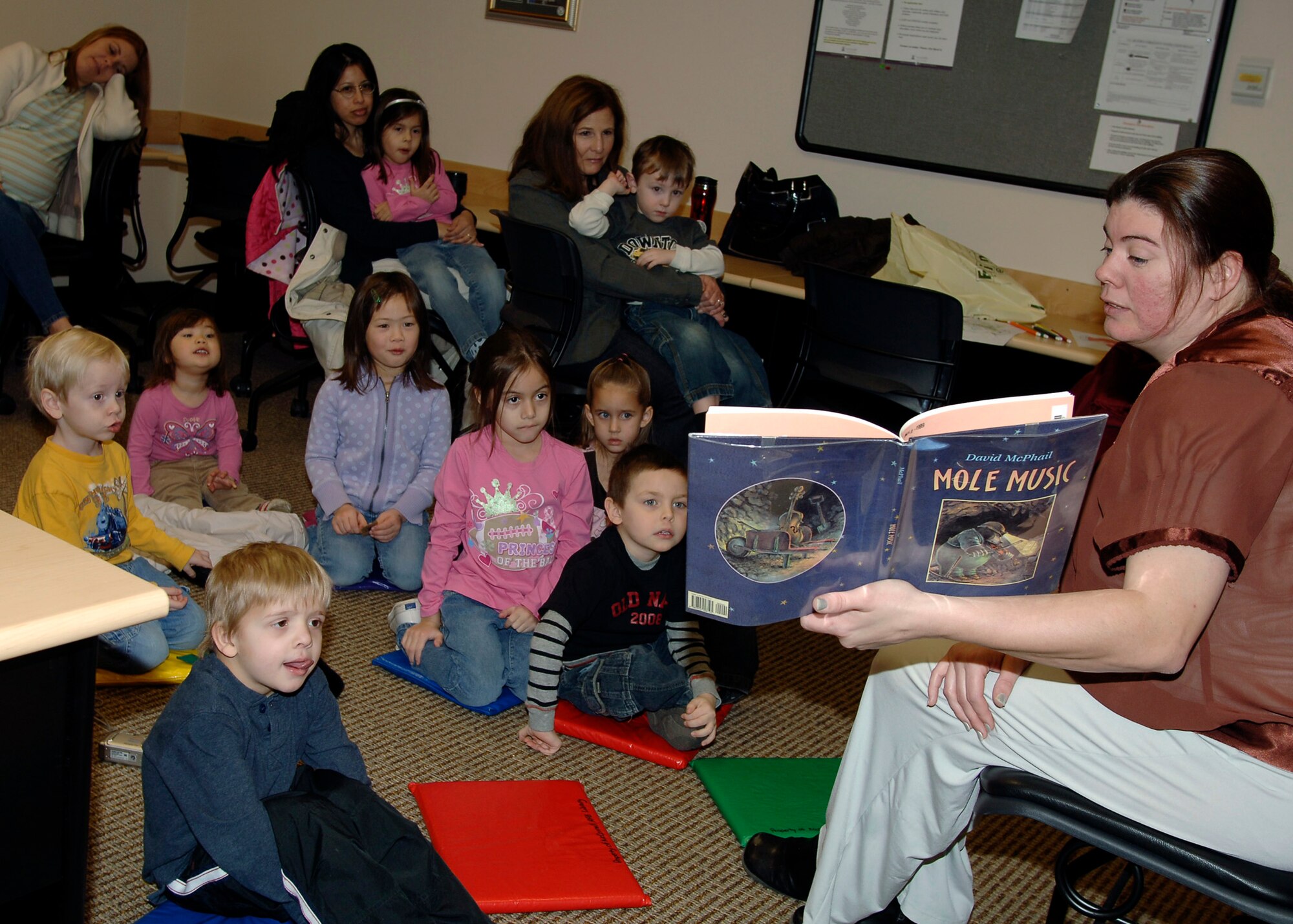 MCCONNELL AIR FORCE BASE, Kan. -- Gretchen Huber, 22nd Force Support Squadron library technician reads a story to preschool children at the base library, Jan. 13. Reading to young children enhances their basic reading skills before entering grade school. (Photo by Senior Airman Anthony Mejia)