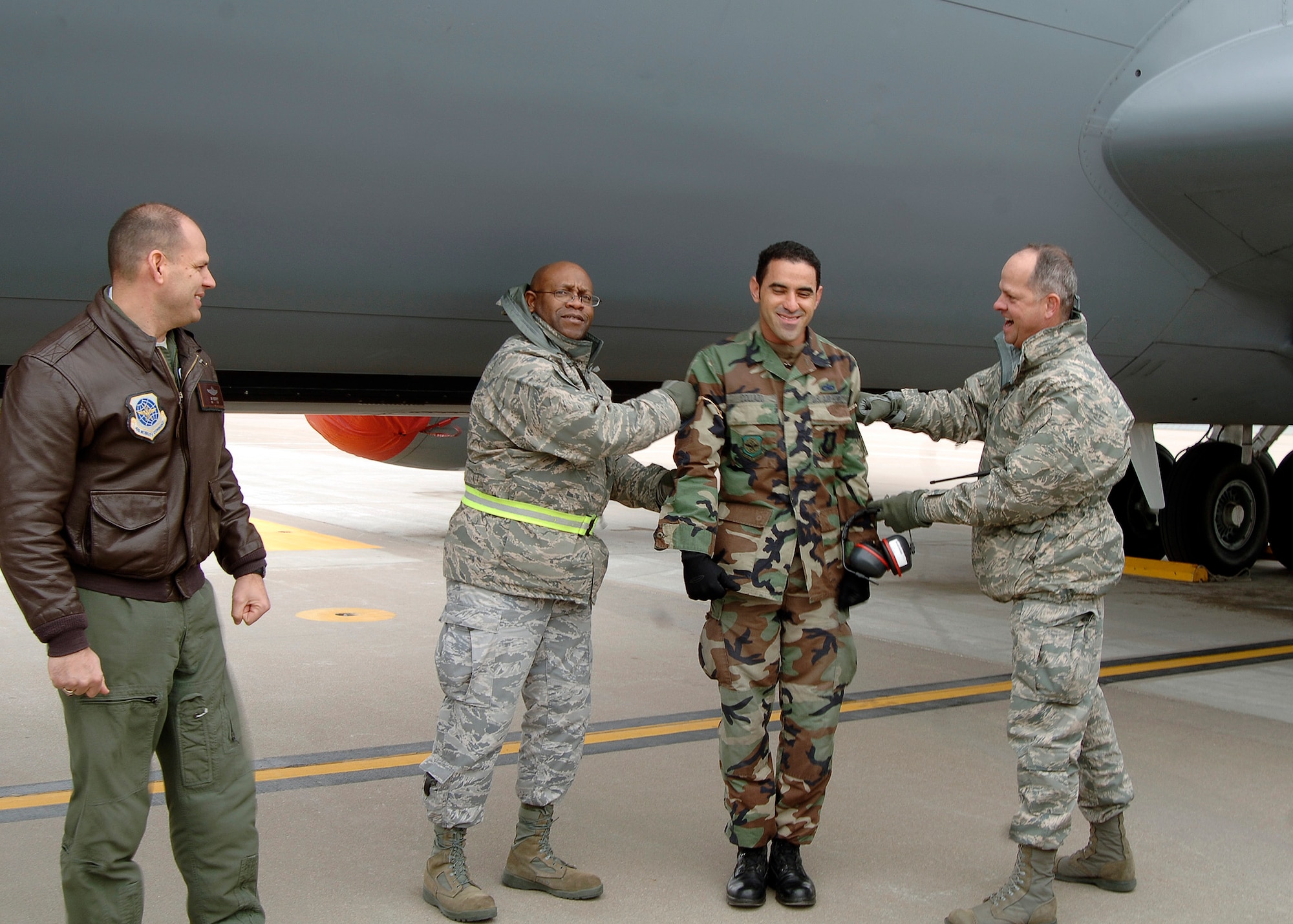 MCCONNELL AIR FORCE BASE, Kan. -- Col. Michael Dillard, 22nd Maintenance Group commander, and Maj. William Holt, 22nd Aircraft Maintenance Squadron commander, pin technical sergeant stripes on Staff Sgt. Manuel Collazo, 22nd Aircraft Maintenance Squadron, on the base flightline, Jan. 14. Sergeant Manuel was promoted through the Stripes for Exceptional Performers program, which is used to reward an outstanding  Airman who distinguishes themselves through hard work and superior performance. (Photo by Senior Airman Anthony Mejia)