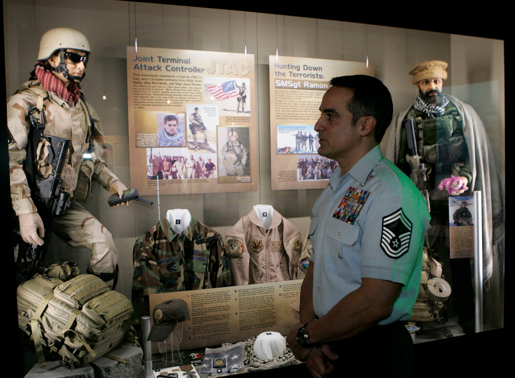 DAYTON, Ohio - Senior Master Sgt. Ramon Colon-Lopez (left) looks at the new "Warrior Airmen" exhibit at the National Museum of the U.S. Air Force.  The  mannequinn on the right represents how he looked as a pararescueman during combat search and resue missions in Afghanistan. (Photo by Ron Alvey, Dayton Daily News)   