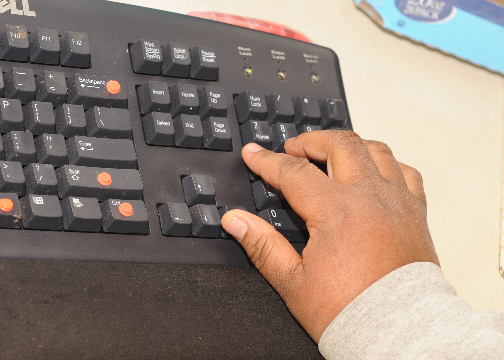 SCOTT AIR FORCE BASE, Ill.-- Mrs. Fortner demostrates her specialized keyboard with Braille lettering and tabs to assist her in finding phone numbers requested by callers. (U.S. Air Force photo/Airman 1st Class Wesley Farnsworth) 