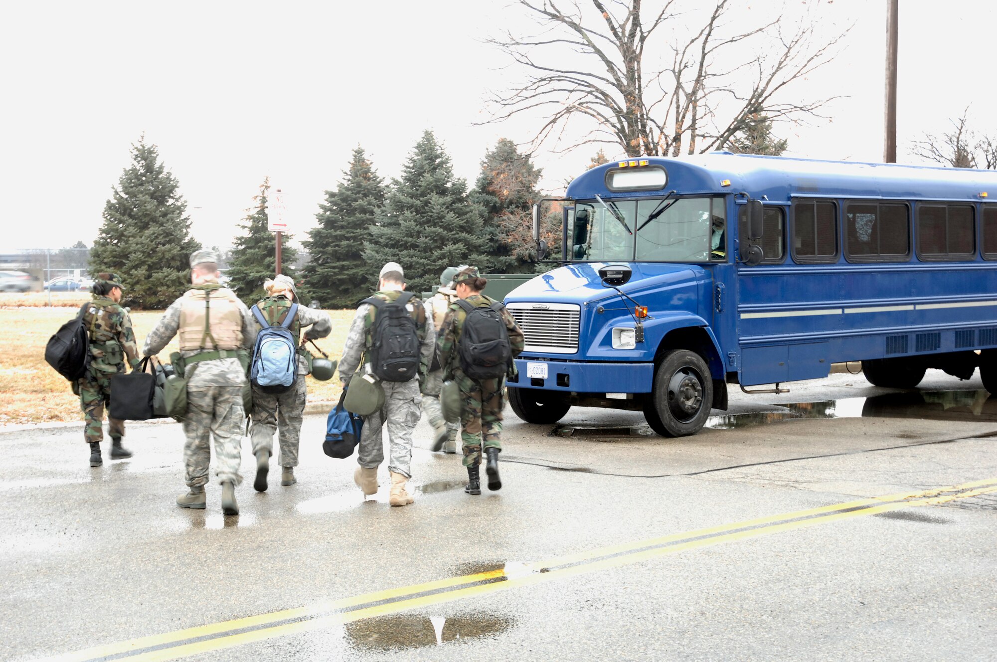 Airmen in the first “chalk” of the base mobility exercise load onto a bus Jan. 13 after checking the inventories of their A and C-bags at the Wright-Patterson Air Force Base mobility bag warehouse.  The exercise, held Jan. 12-14, simulated mass deployment of 140 base airmen to Kabul, Afghanistan. (U.S. Air Force photo/ Al Bright)