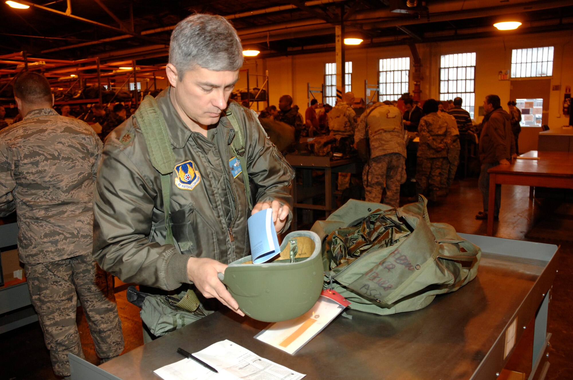 Maj. Gus Vitali, 702nd Aeronautical Systems Group, inventories the contents of his A-bag Jan. 13 at the Wright-Patterson Air Force Base mobility bag warehouse.  Vitali was among 140 base Airmen to participate in a mobility exercise Jan. 12-14 which trained and evaluated Airmen’s basic combat readiness skills. 