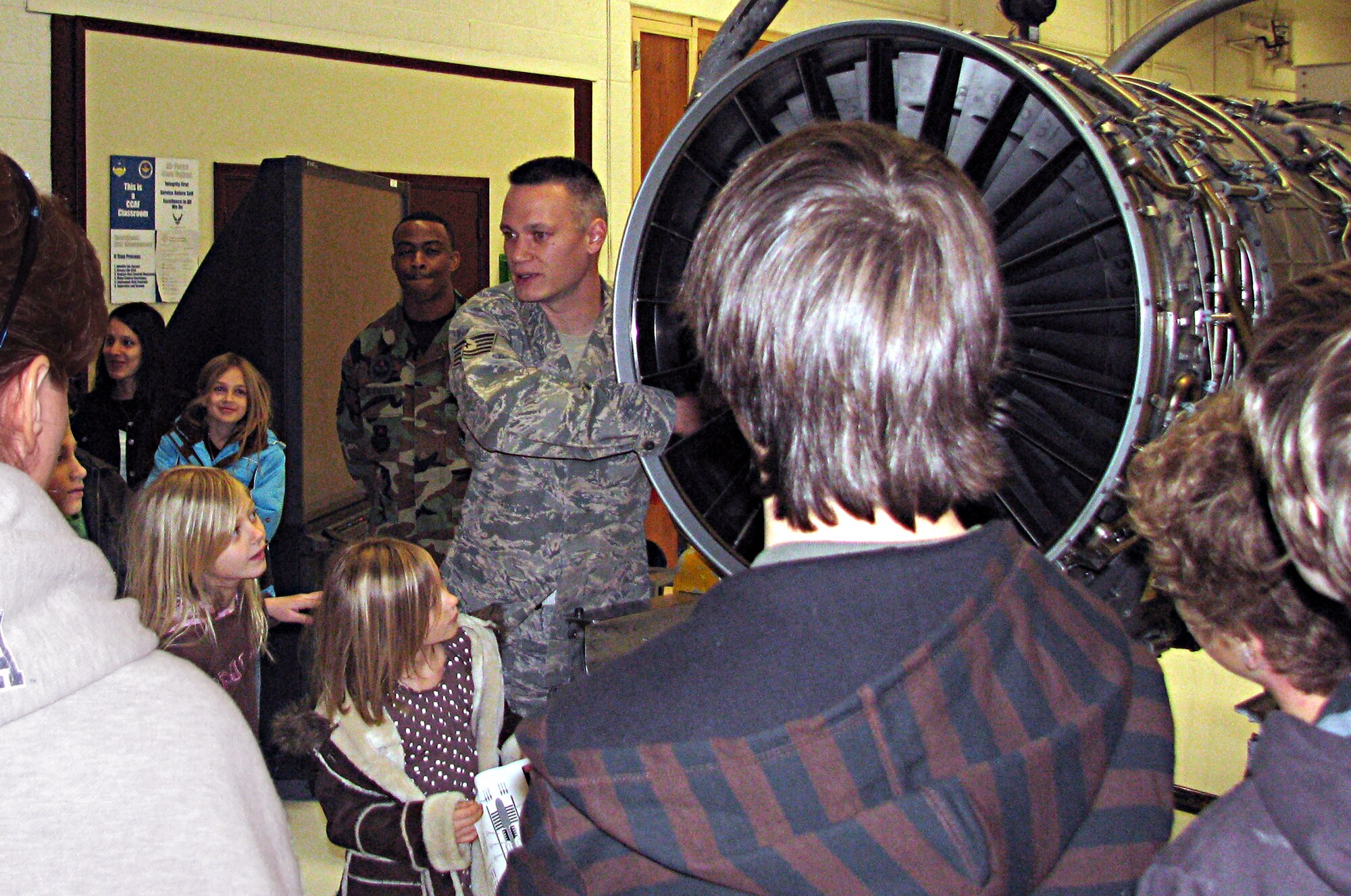 Tech. Sgt. Ivan Niska, 372nd Training Squadron Det. 13 instructor, teaches members of the Henderson Nevada Homeschool Group about the Pratt & Whitney F-100 220 Engine during their tour of Det. 13 training facility Dec. 30. (Courtesy photo) 
