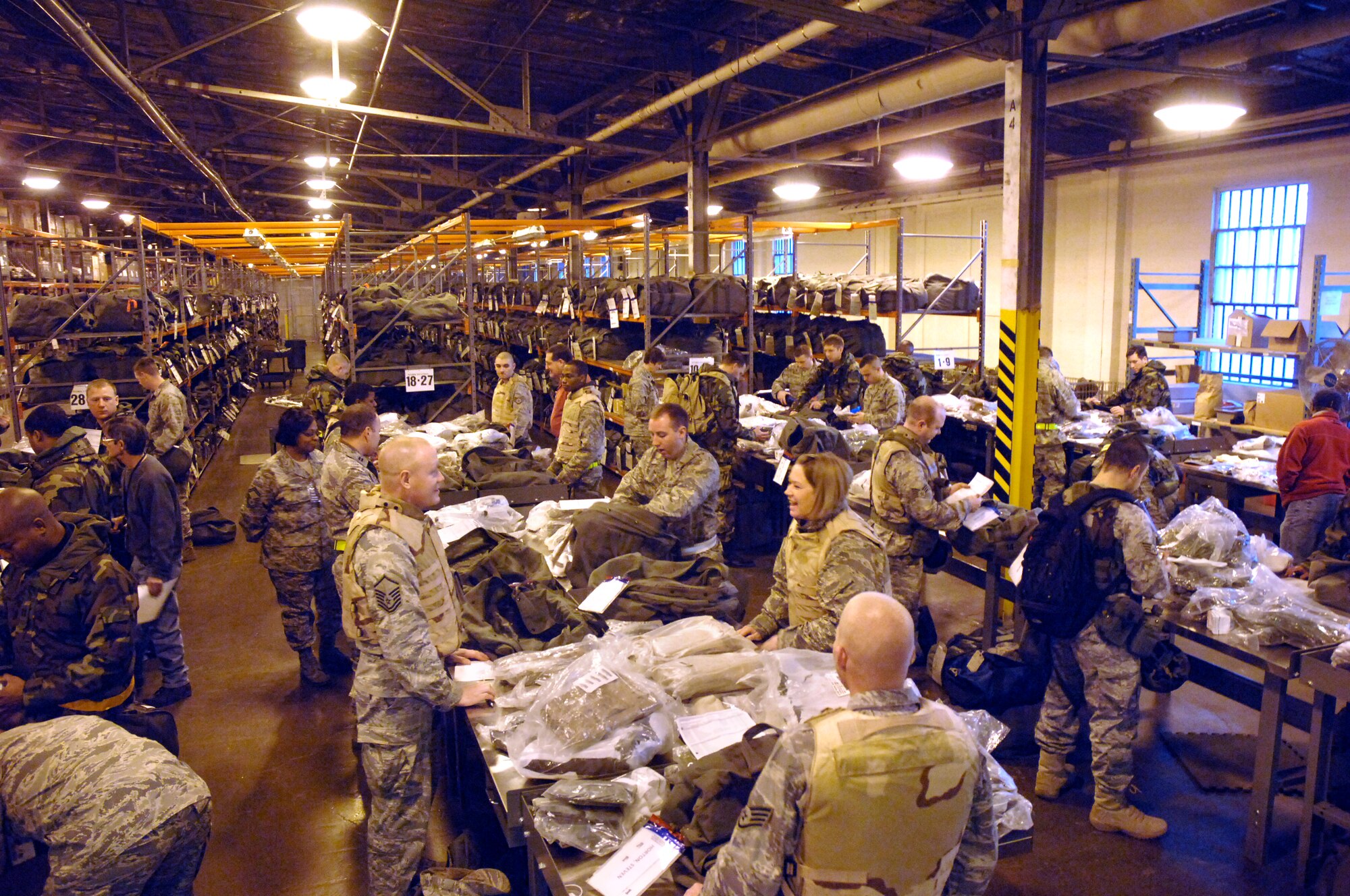 Airmen in the first “chalk” of the base mobility exercise check inventory of their A and C-bags Jan. 13 at the Wright-Patterson Air Force Base mobility bag warehouse.  The exercise, held Jan. 12-14, simulated mass deployment of 140 Airmen to Kabul, Afghanistan. (U.S. Air Force photo/Al Bright)