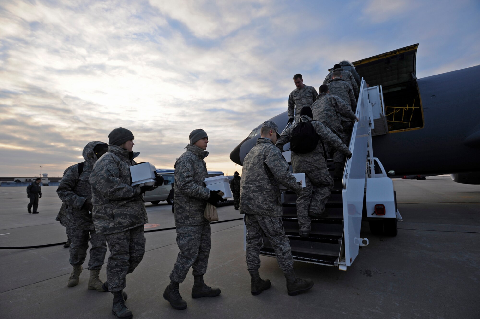 Some of the newest active-duty Airmen at McConnell Air Force Base, Kan., board a KC-135 Stratotanker on the base flightline in the cold, early morning of Jan. 10. They later watched another KC-135 from McConnell receive fuel from the tanker while in flight. Crews from the 931st Air Refueling Group, an Air Force Reserve unit at McConnell, flew both aircraft. (U.S. Air Force photo/Tech. Sgt. Jason Schaap)