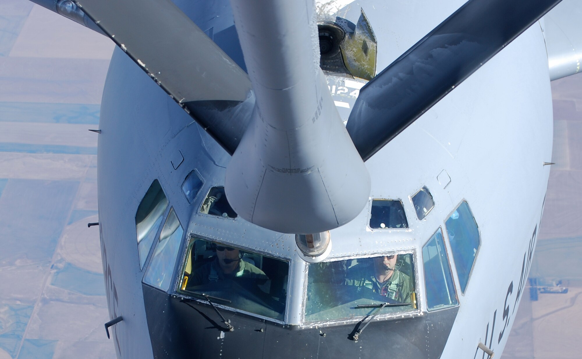 Maj. Nathan Dennes (on left) and Capt. Scott Davis approach the refueling boom of a KC-135 Stratotanker while flying a receiver-capable KC-135 from McConnell Air Force Base, Kan. Major Dennes and Captain Davis are active-duty pilots assigned to the 22nd Air Refueling Wing. They teamed with Reserve KC-135 crew members from the 931st Air Refueling Group to make the total-force mission possible. The 22nd ARW is the 931st's host unit at McConnell. (U.S. Air Force photo/Tech. Sgt. Michael Kissire)