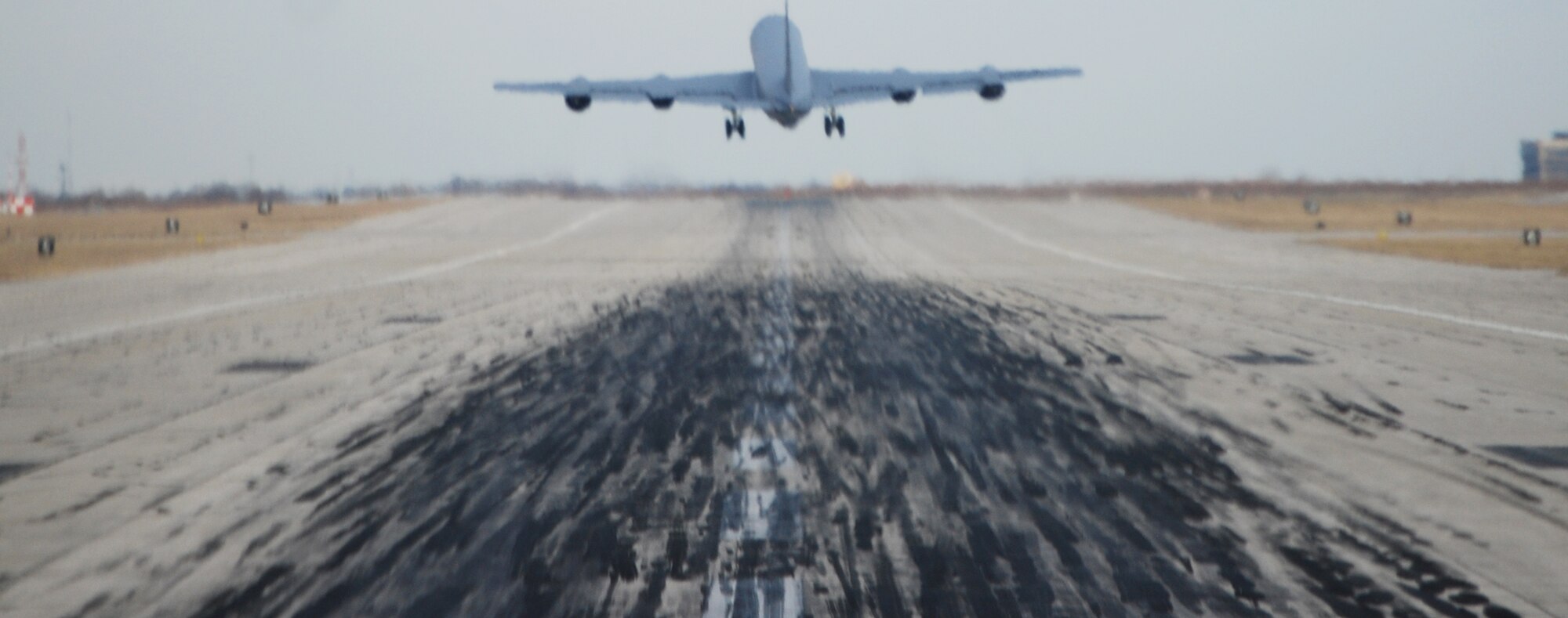 A departing KC-135 Stratotanker creates a hazy view for the crew of another KC-135 about to take off behind it at McConnell Air Force Base, Kan. The two tankers were part of a flying formation involving four KC-135s, a rare occurrence in the KC-135 world. (U.S. Air Force photo/Tech. Sgt. Michael Kissire)
