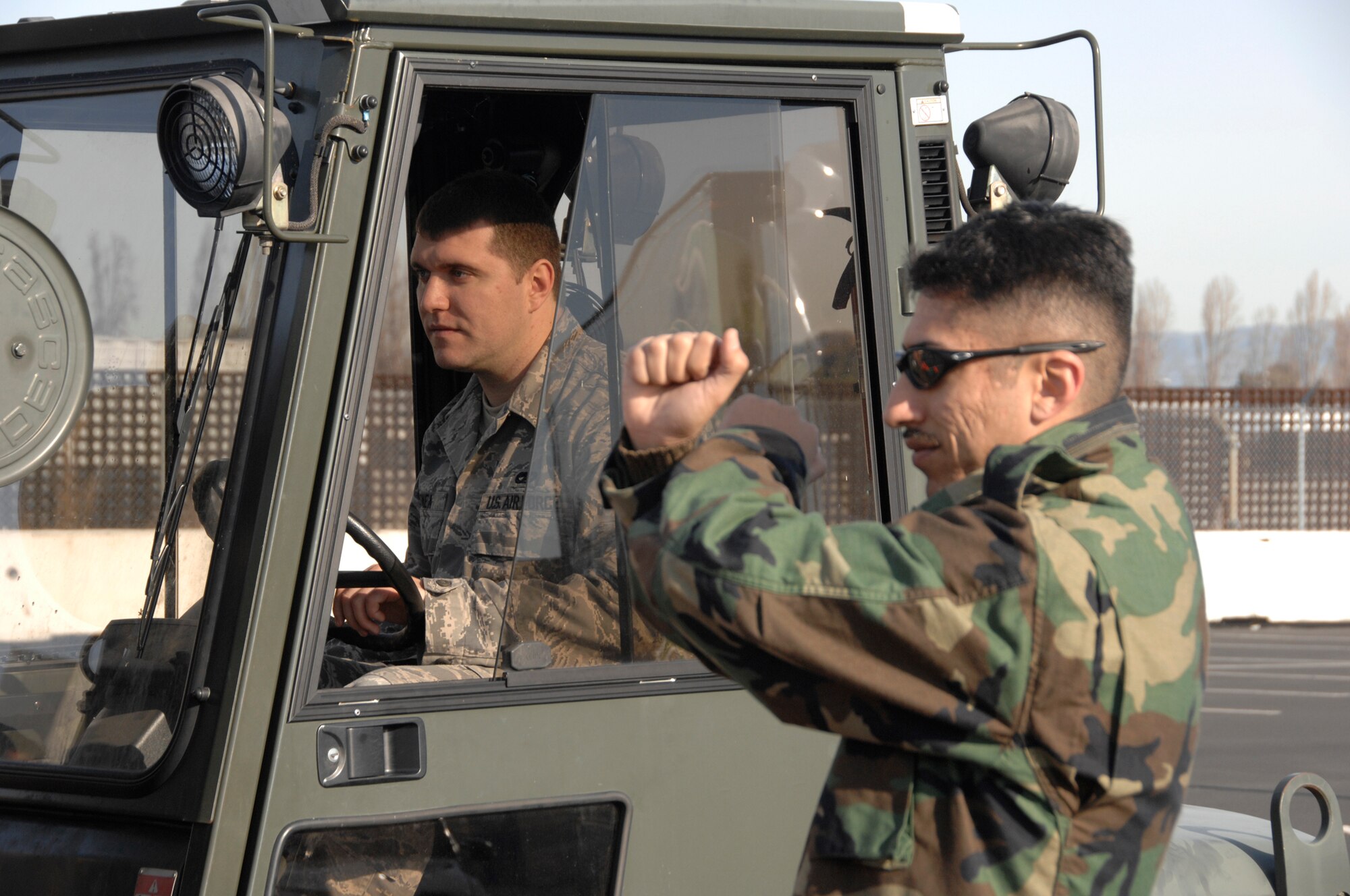 129th Aerial Port Flight personnel perform safety training at Moffett Federal Airfield, Jan. 4. Senior Airman Razvan Sonea operates a forklift while Staff Sgt. Felipe Mancera demonstrates safety procedures. The 129th Logistics Readiness Squadron’s Aerial Port Flight stood up Nov. 1, 2008. 129th Aerial Port personnel, also known as “Port Dogs,” are specialized Airmen trained to manage in-transit passenger and cargo movements for state directed missions and AEF deployments, redeployments, and exercises. (U.S. Air Force photo by Senior Airman Joshua Kauffman)(RELEASED)