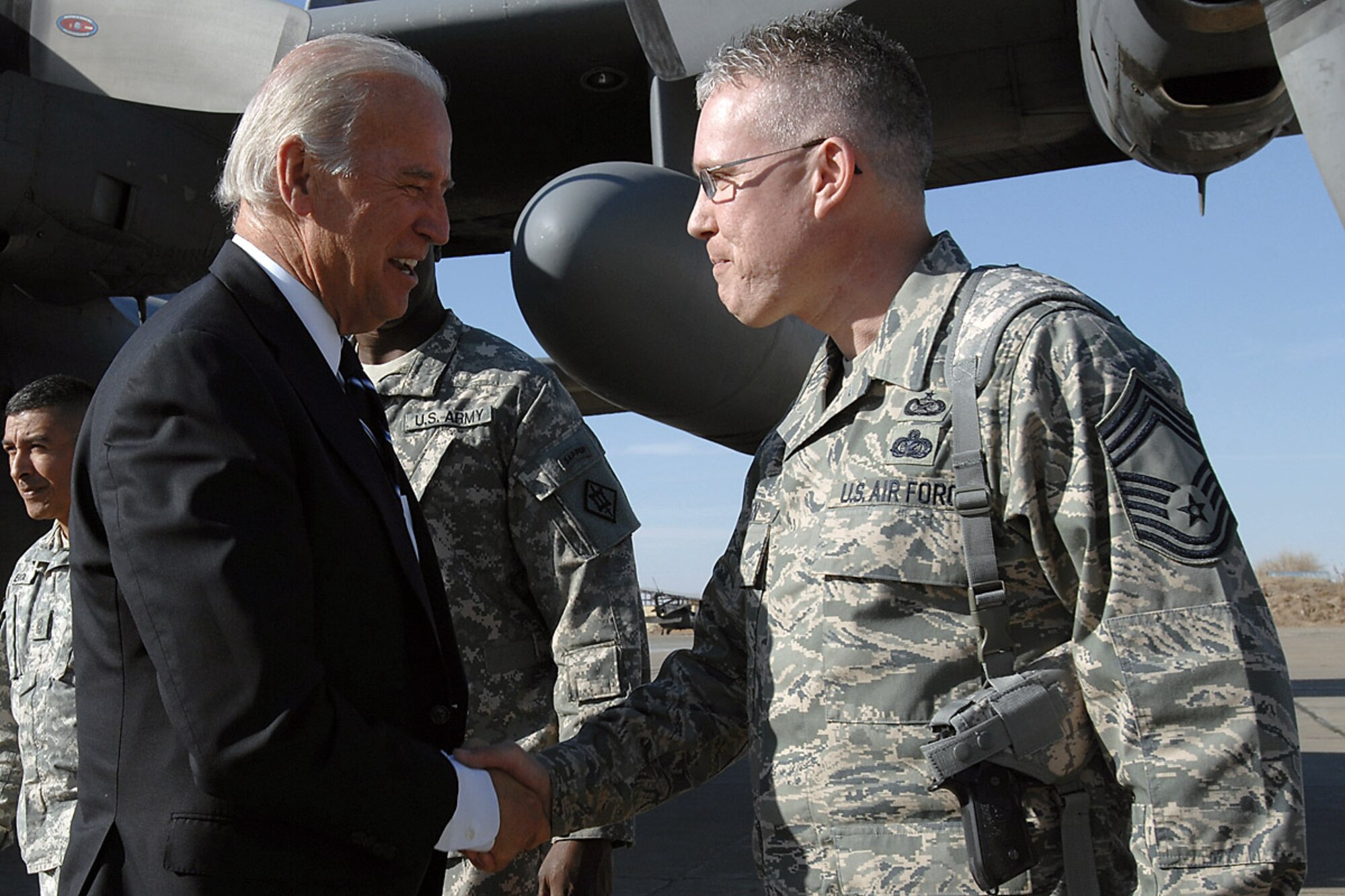 Chief Master Sgt. Bill Goben greets Vice President-elect Joe Biden upon his arrival Jan. 13 to Kirkuk Air Base, Iraq. Chief Goben is the 506th Air Expeditionary Group superintendent and is deployed here from the Pentagon. (U.S. Air Force photo/Senior Airman Eunique Stevens) 
