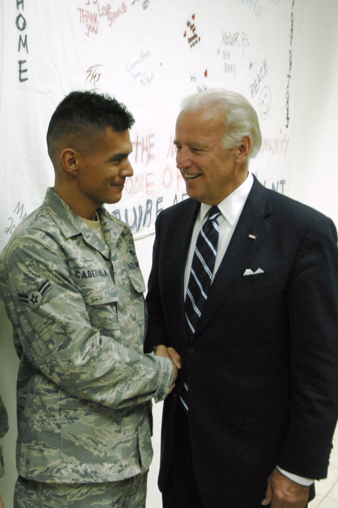 Vice president-elect Joe Biden shakes hands with Airman 1st Class Jose Cabezuela Jan. 13 at Kirkuk Air Base, Iraq. The Heresord, Texas, native was among the servicemembers the senator thanked for their service. Airman Cabezuela is assigned to the 506th Expeditionary Logistics Readiness Squadron and is deployed from Kirtland Air Force Base, N.M. (U.S. Air Force photo/Airman 1st Class Jessica Lockoski) 
