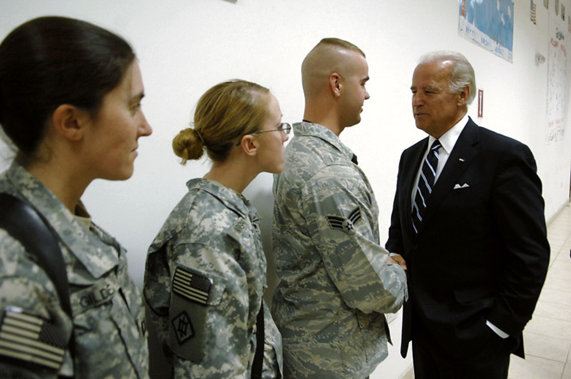 Vice president-elect Joe Biden meets Soldiers and Senior Airman Steven Brown Jan. 13 at Kirkuk Air Base, Iraq. The Grand Rapids, Mich., native was among the Airmen here who the senator thanked for their service. Airman Brown is assigned to the 506th Expeditionary Security Forces Squadron and deployed from Eielson Air Force Base, Alaska. (U.S. Air Force photo/Airman 1st Class Jessica Lockoski) 
