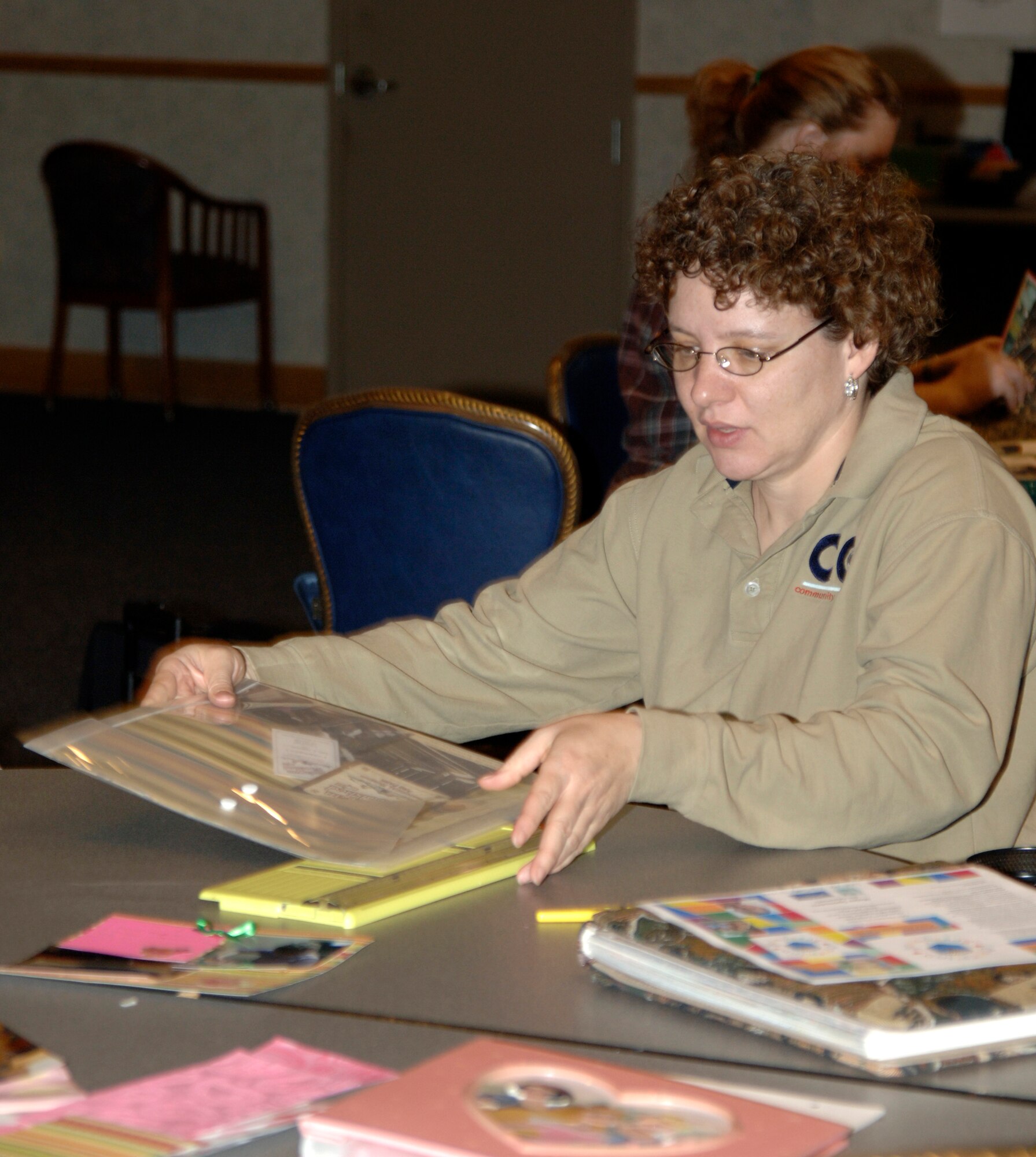 MCCONNELL AIR FORCE BASE, Kan. -- Sharon Banks, 22nd Force Support Squadron, leads the scrapbook and rubber stamp crop program at the Robert J. Dole Community Center ballroom, Jan. 10. The scrapbook and rubber stamp crop program allows Team McConnell members to engage in some creative activities in a social environment. (Photo by Senior Airman Laura Suttles)