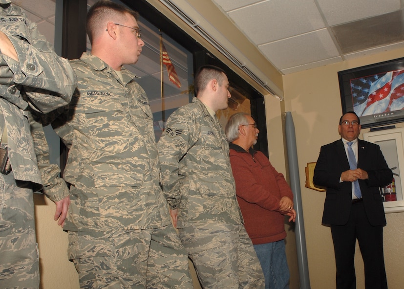 Dr. Fred Lewis (right), the Air Force Director of Weather, pays a visit to the 56th Operations Support Squadron weather flight to coin four Airmen on Jan. 13.  The individuals receiving coins were Staff Sgt. Adam D'Anthony, Staff Sgt. George Zambrana, Staff Sgt. Mike Gerlach, and Master Sgt. James Scott Dixon.  (U.S. Air Force photo by Airman 1st Class Ronifel Yasay)  