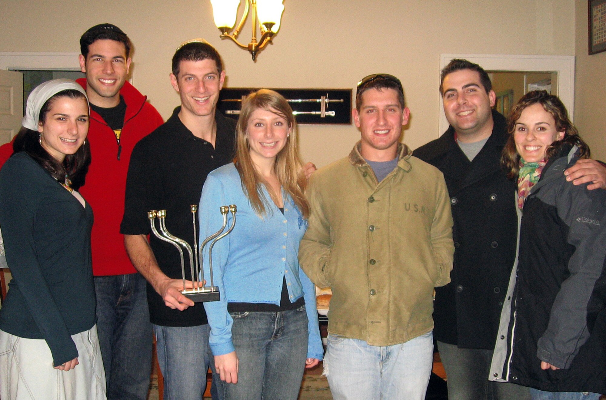 Michelle Goldstein, far left, 2nd Lt. Jonathan Goldstein, far left, 1st Lt. Michael Lebovitz, center left, Arielle Dani Lebovitz, center, 2nd Lt. Marc Goodman, center right, Capt. Daniel Lapidus, far right, and Melissa Seror with celebrate Chanukah with a dinner party on Dec. 21. (courtesy photo)