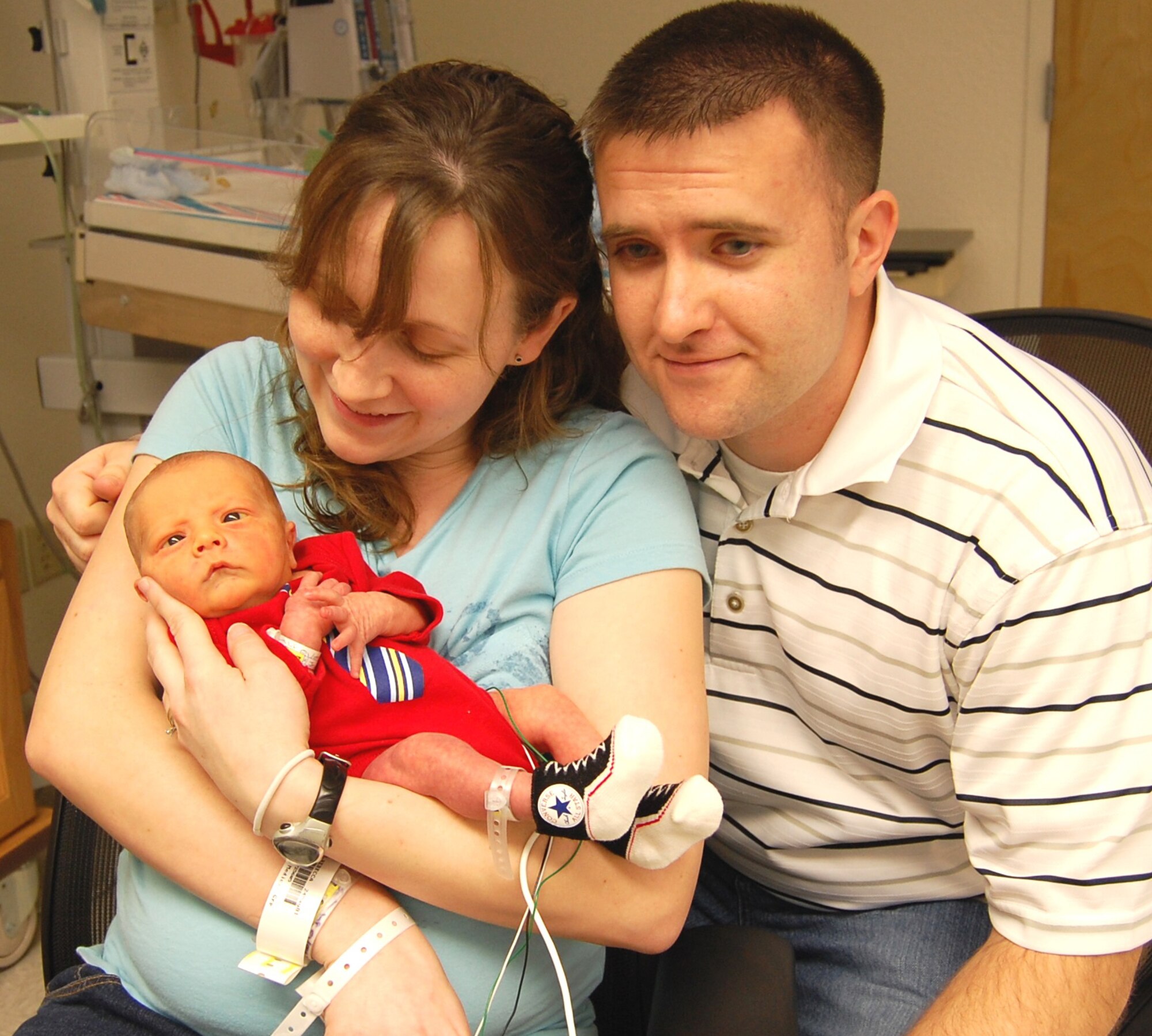 First-time parents Rebecca and Staff Sgt. Granville Smith hold son Granville Arden Jan. 7 in Keesler Medical Center’s neonatal intensive care unit.  Granville, born at 7:29 p.m. Jan. 4, was Keesler’s first baby of 2009.  He weighed 5 pounds, 12 ounces and was 19 inches long.  The 81st Inpatient Operations Squadron maternal child flight presented the family a basket of baby items.  Sergeant Smith is a member of the 85th Engineering Installation Squadron.  (U.S. Air Force photo by Steve Pivnick)