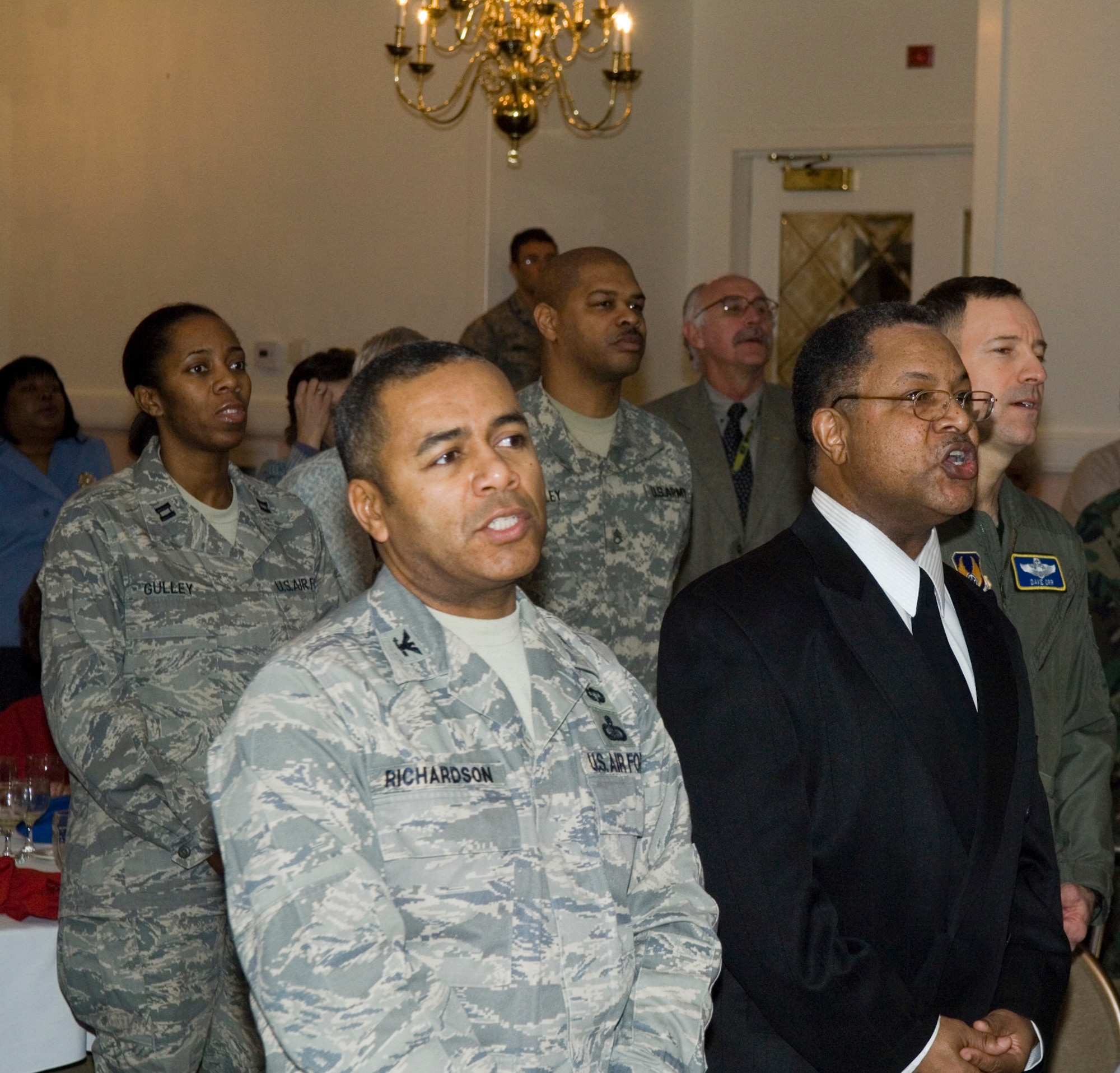 Attendees and participants sing the hymn "Lift Every Voice and Sing" together at the Martin Luther King Jr. Observance Breakfast at the Minuteman Club Jan. 13.  (U.S. Air Force photo by Rick Berry)