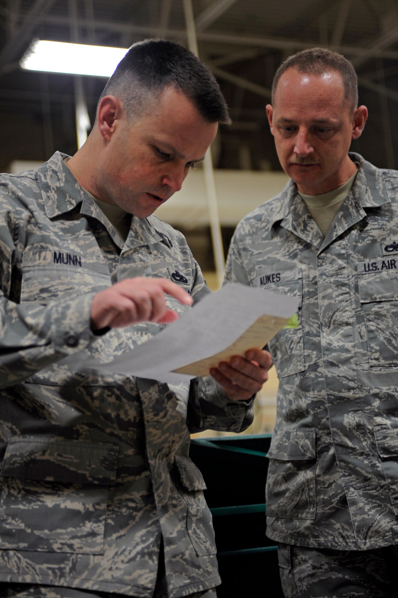 (Left) Master Sgt. Trey Munn, Air Combat Command fabrication evaluator, reviews an item list with Tech. Sgt. Steven Aukes, 28th Maintenance Squadron aircraft structure section chief, here Jan. 13.  Sergeant Munn is with the Logistics Standardization and Evaluation Team, inspecting all maintenance and logistics career fields at Ellsworth for one week.  (U.S. Air Force photo/Airman 1st Class Matthew Flynn)
