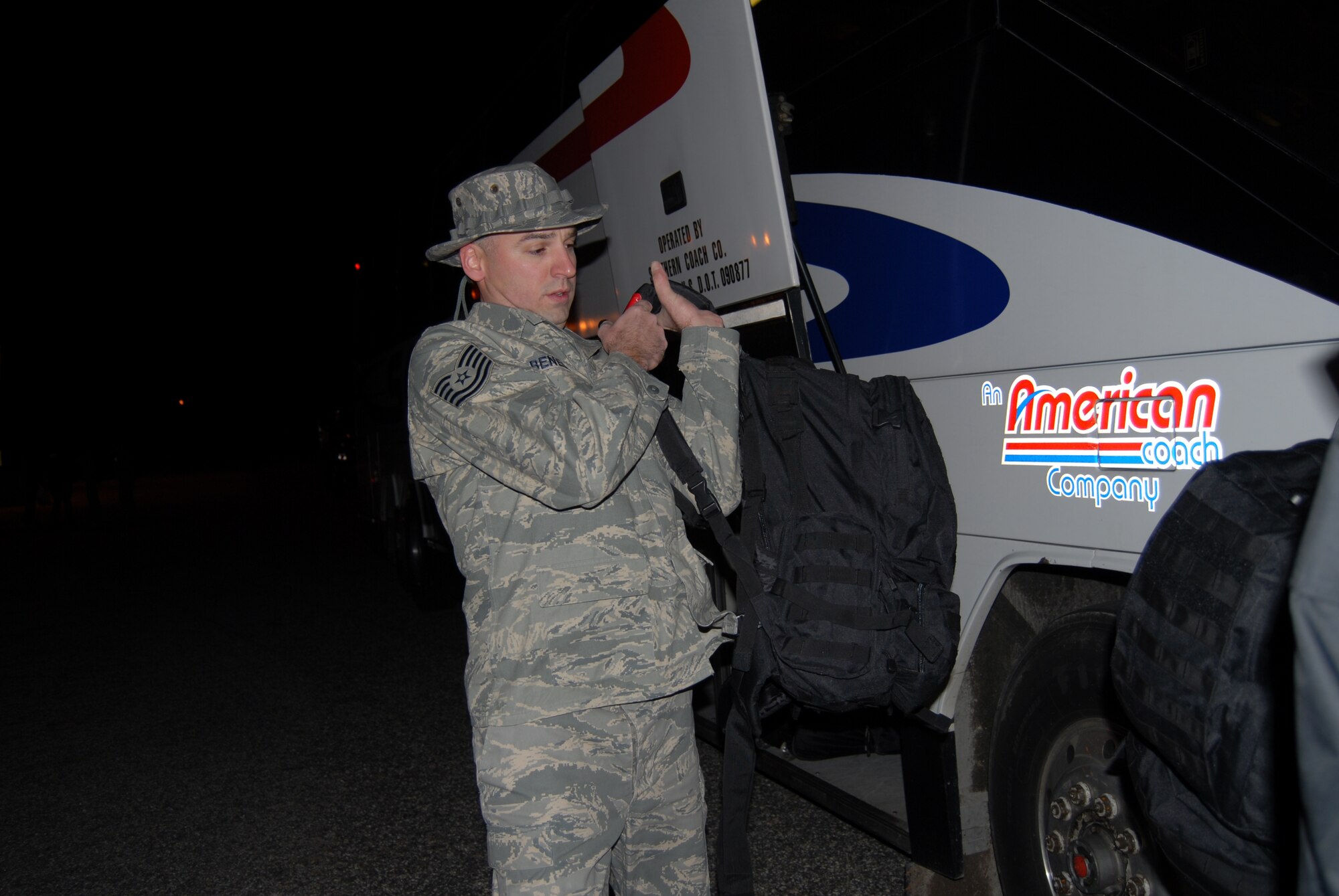 Tech. Sgt. Alexander Benedict, 43rd Civil Engineer Squadron, boards a bus at the 43rd Logistics Readiness Squadron building before leaving for a six-month deployment to Southwest Asia Dec. 7. (U.S. Air Force Photo by Airman 1st Class Mindy Bloem)