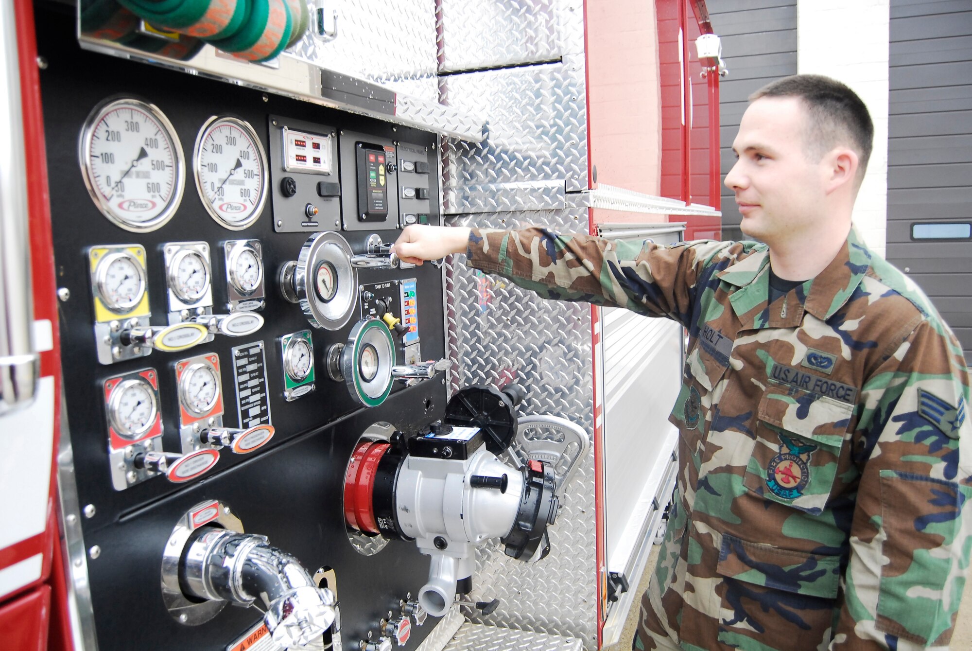 Senior Airman Patrick Holt, 43rd Civil Engineer Squadron, checks the water pump on a fire truck to ensure it is in proper working order. (U.S. Air Force Photo by Emily Farrington-Smith)