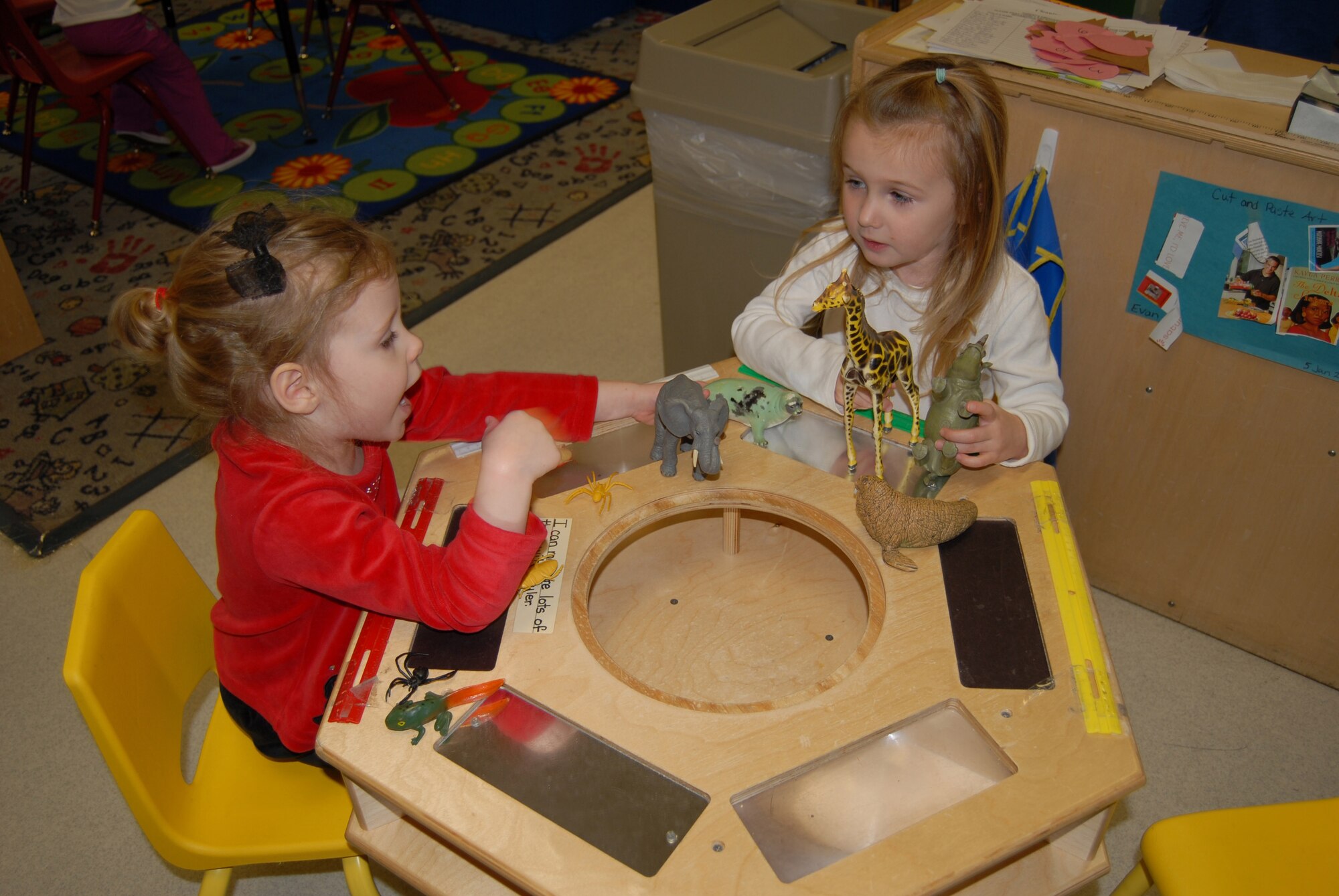 Alexis Opal (left), 3, and Hailey Wilson, 3, play with toys together at the Child Development Center Jan. 8. (U.S. Air Force Photo by Airman 1st Class Mindy  Bloem)