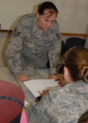 Staff Sgt. Cala Grier, 43rd Force Support Squadron, signs for her technical sergeant testing date at the Airman Leadership School building Jan. 9. More than 1,000 eligible staff and technical sergeants, testing for their next rank, signed for their test dates between Friday and Monday. (U.S. Air Force Photo by Tech. Sgt. Todd Wivell)