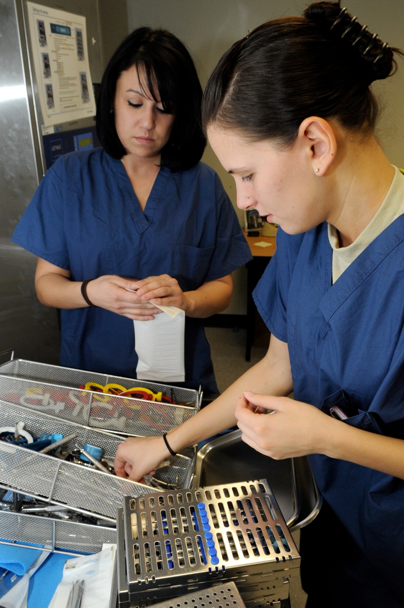 Senior Airman Brittany Levy and Valerie Jones, both 305th Dental Squadron dental technicians, sterilize all the dental instruments used at clinic in the Dental Instrument Processing Center Jan. 9. Airman Levy is also in charge of Infection Control, requiring her to inspect each dental room and ensure compliance with Air Force and Occupational Health and Safety guidelines. (U.S. Air Force photo/Wayne Russell)