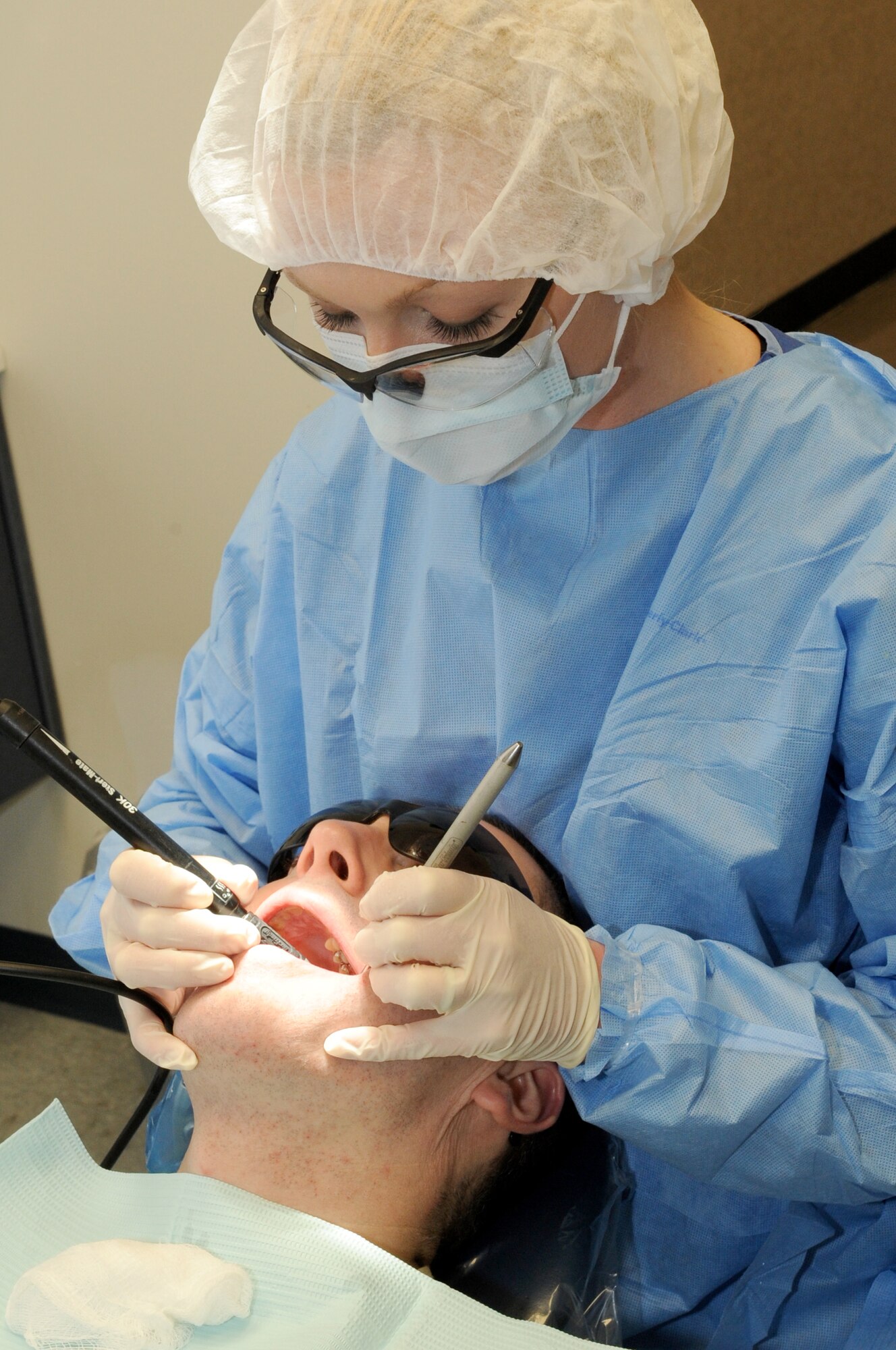 Tech. Sgt. Joe Sienkiewicz, 360th Recruiting Squadron, gets his preventive cleaning done by Staff Sgt. Michelle Story, 305th Dental Squadron prophy technician. Cleanings are done annually for Airmen, unless a problem arises in between. (U.S. Air Force photo/Wayne Russell)