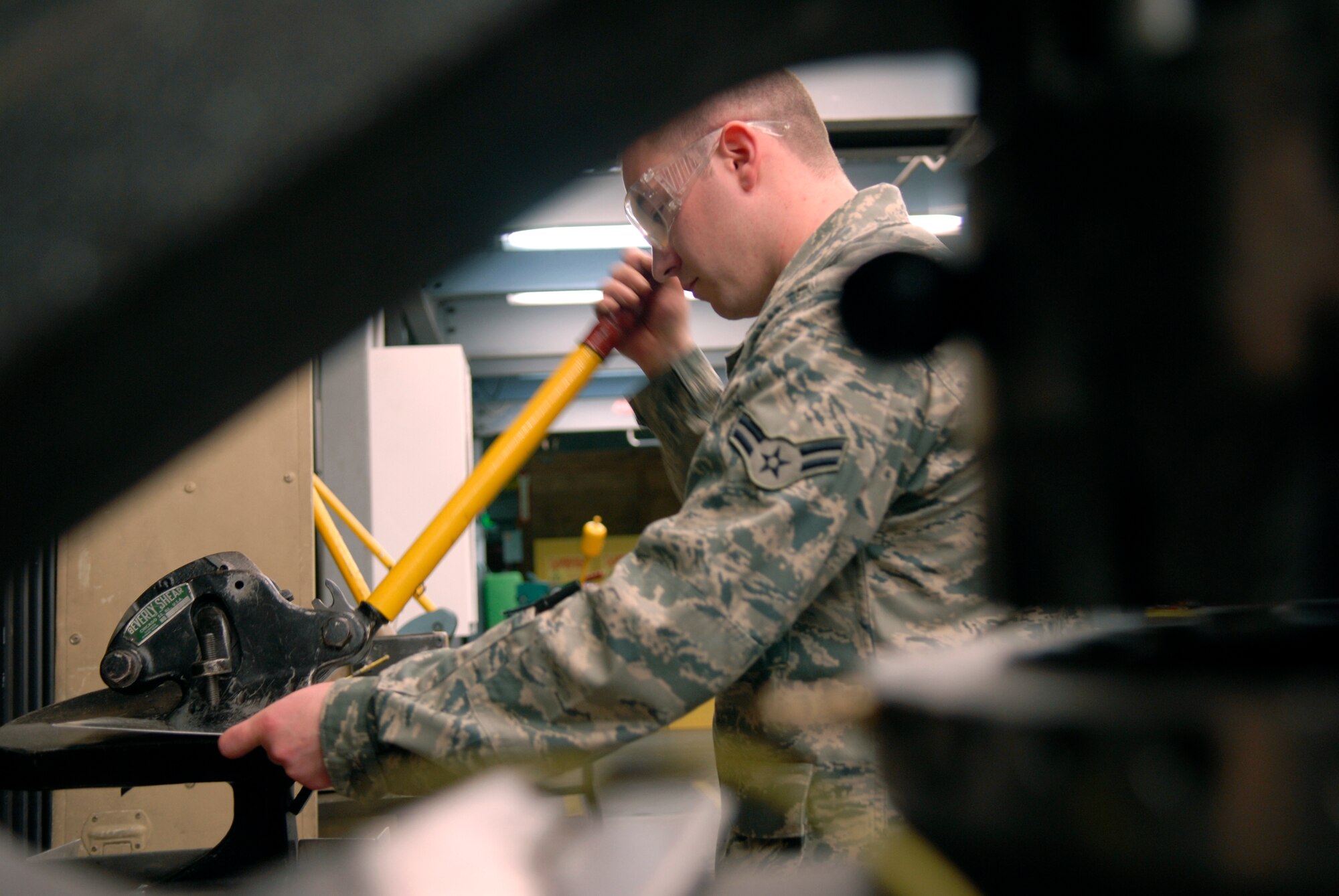 Airman 1st Class Jeremy Staten, a 379th Maintenance Squadron Aircraft Structural Maintenance Apprentice, cuts sheet metal for a bonding repair for a P-3 Aircraft internal door Jan. 13, 2009, at an undisclosed location in Southwest Asia.  Airman 1st Class Staten hails from Carriere, Miss. and is deployed from Tinker Air Force Base, Okla.  Airmen in the sheet metal shop work on a variety of aircraft from C-130's to KC-135's in support of Operation Iraqi and Enduring Freedom, and Joint Task Force- Horn of Africa.   (U.S. Air Force Photo by Airman 1st Class Andrew Satran/Released) 