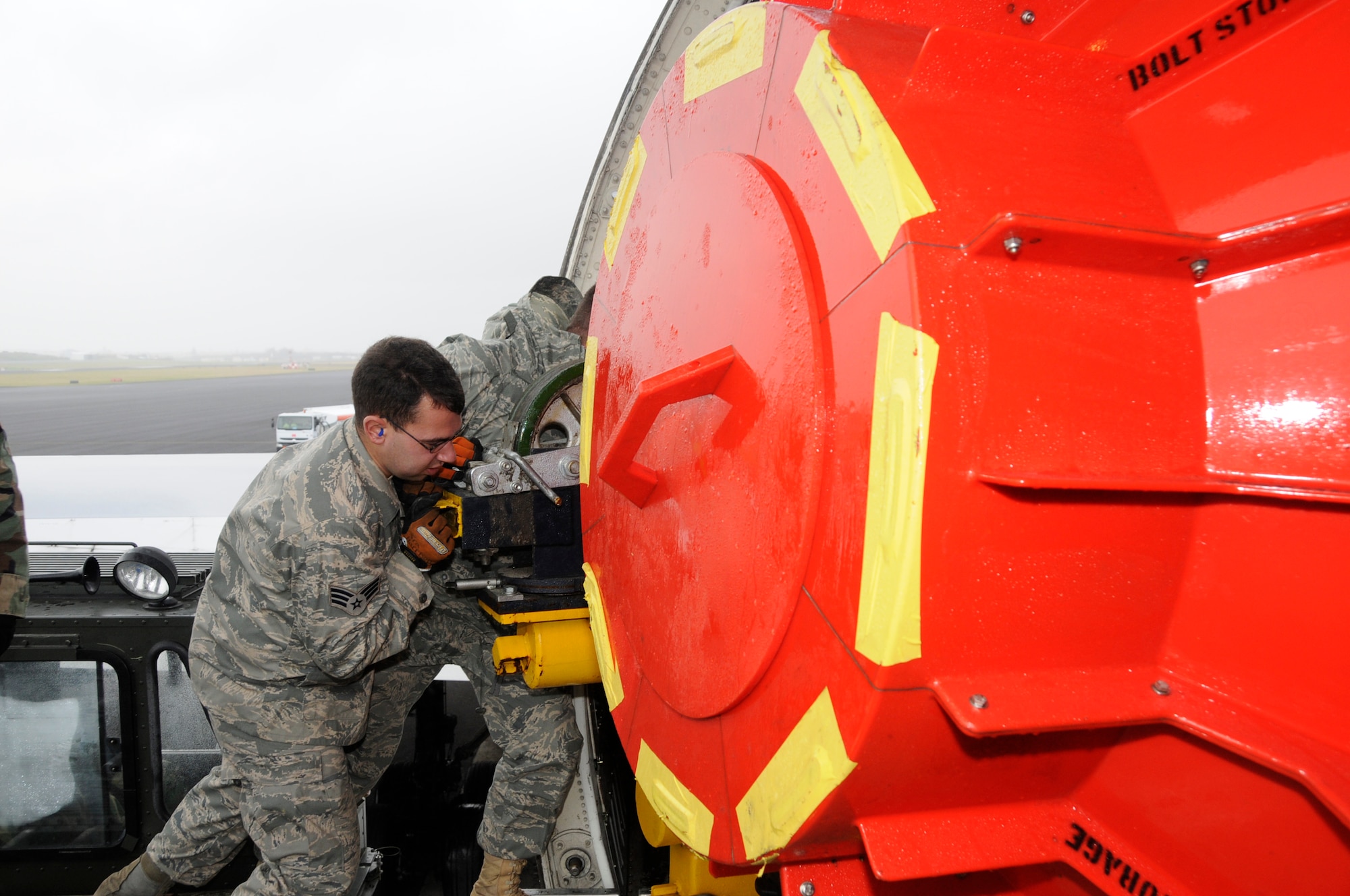 Senior Airman Joseph Harrison, 729th Air Mobility Squadron, and Master Sgt. Eric Pieper, 729 AMS, assist in loading a defective engine into an Air France 747 cargo plane here on Jan 13. Last week Air Force personnel assisted the Portuguese and Air France in unloading a new engine for an Air France 777 passenger aircraft that made an emergency landing here on Jan 4. (U.S. Air Force photo by Tech. Sgt. Rebecca Corey)