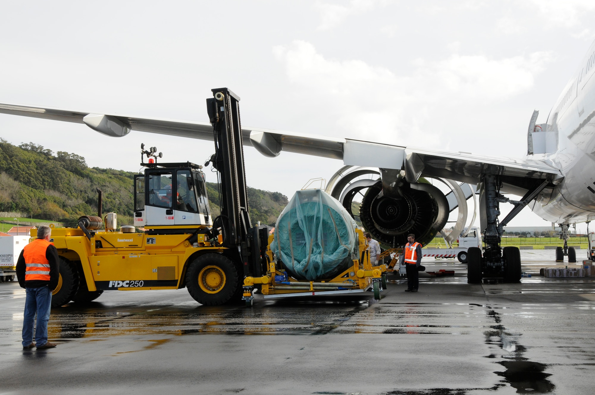 On Jan. 6, the 838th Transportation Battalion, Azores Detachment, brought their forklift down from the port in Praia to the flight line to help support Air France maintainers move a new engine, weighing 22,000 pounds, for a downed Air France 777, which diverted to Lajes Field Jan 4. Airmen from Lajes Field and members of the 838th Transportation Battalion were asked to provide support because local commercial airlines here only have lift equipment that can handle up to 15,000 pounds, did not have the capability to support Air France. (U.S. Air Force photo by Guido Melo)