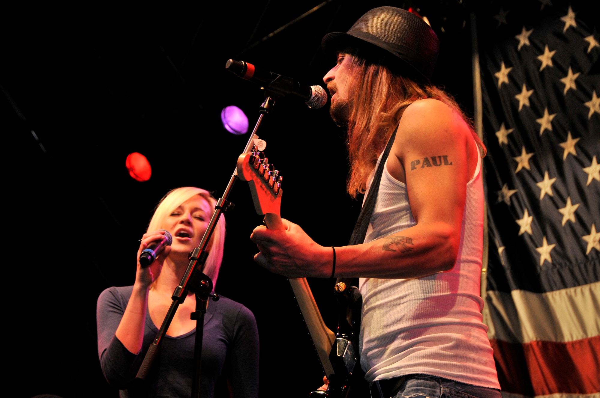 Kid Rock, and Kellie Pickler sing "Picture" to RAF Lakenheath and RAF Mildenhall Airmen and their families during the United Service Organization's Holiday Tour Dec. 20 at RAF Lakenheath, England. The USO holiday tour went to five different countries and included performances by Lewis Black, Kathleen Madigan, Tichina Arnold, and John Bowman. (U.S. Air Force photo by Airman 1st Class Perry Aston)