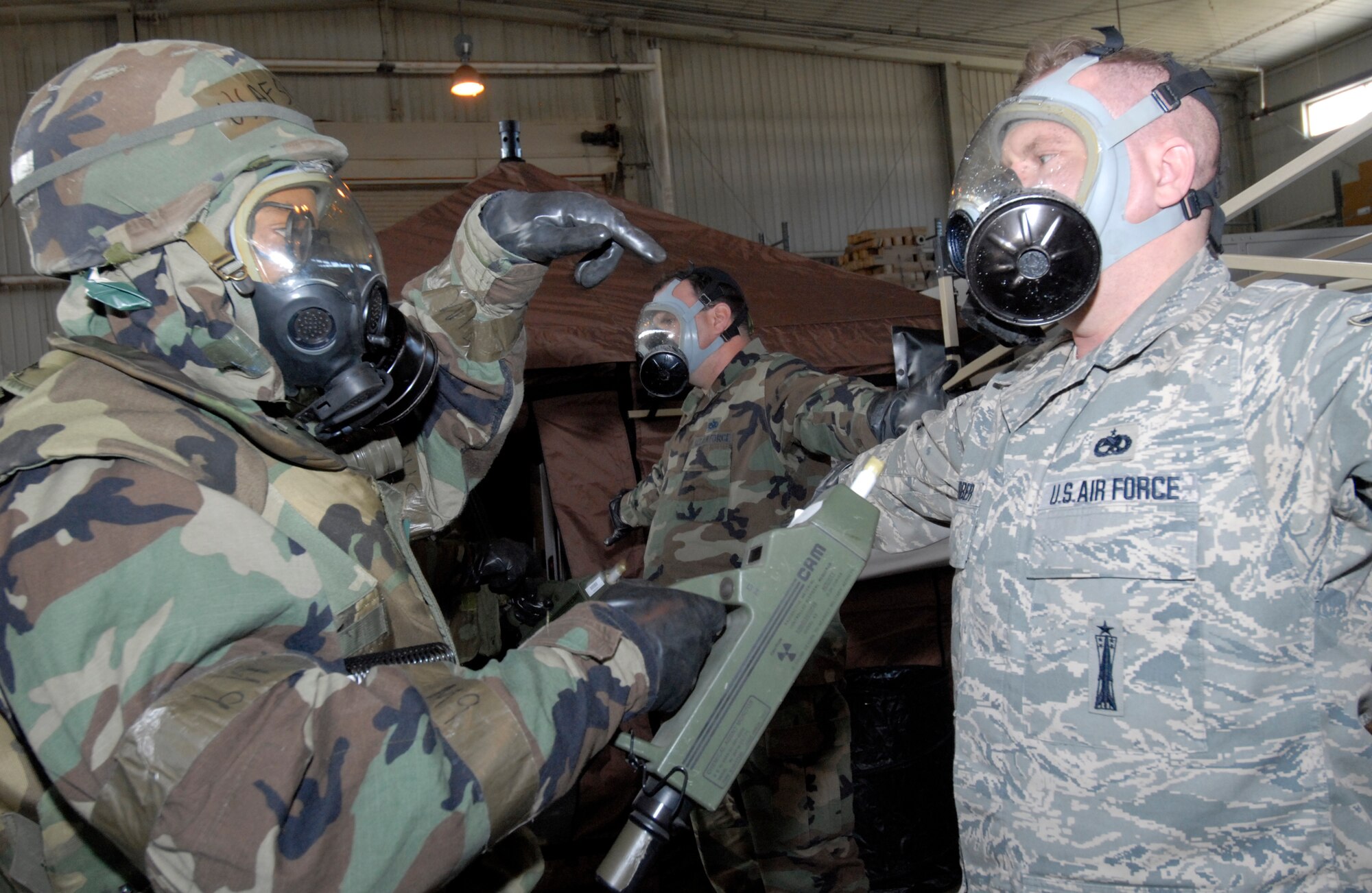 Senior Airman Maurice Ray, 8th Comptroller Squadron, uses a chemical agent monitor to detect contamination on a contaminated individual during the Peninsula-Wide Operational Readiness Exercise at Kunsan Air Base, Republic of Korea, Jan. 14, 2009. Airman Ray is a part of the Controlled Contamination Area team where he assists the processing of contaminated individuals from a contaminated chemical environment to a non-contaminated chemical environment. (U.S. Air Force Photo by Senior Airman Dana Hill)
