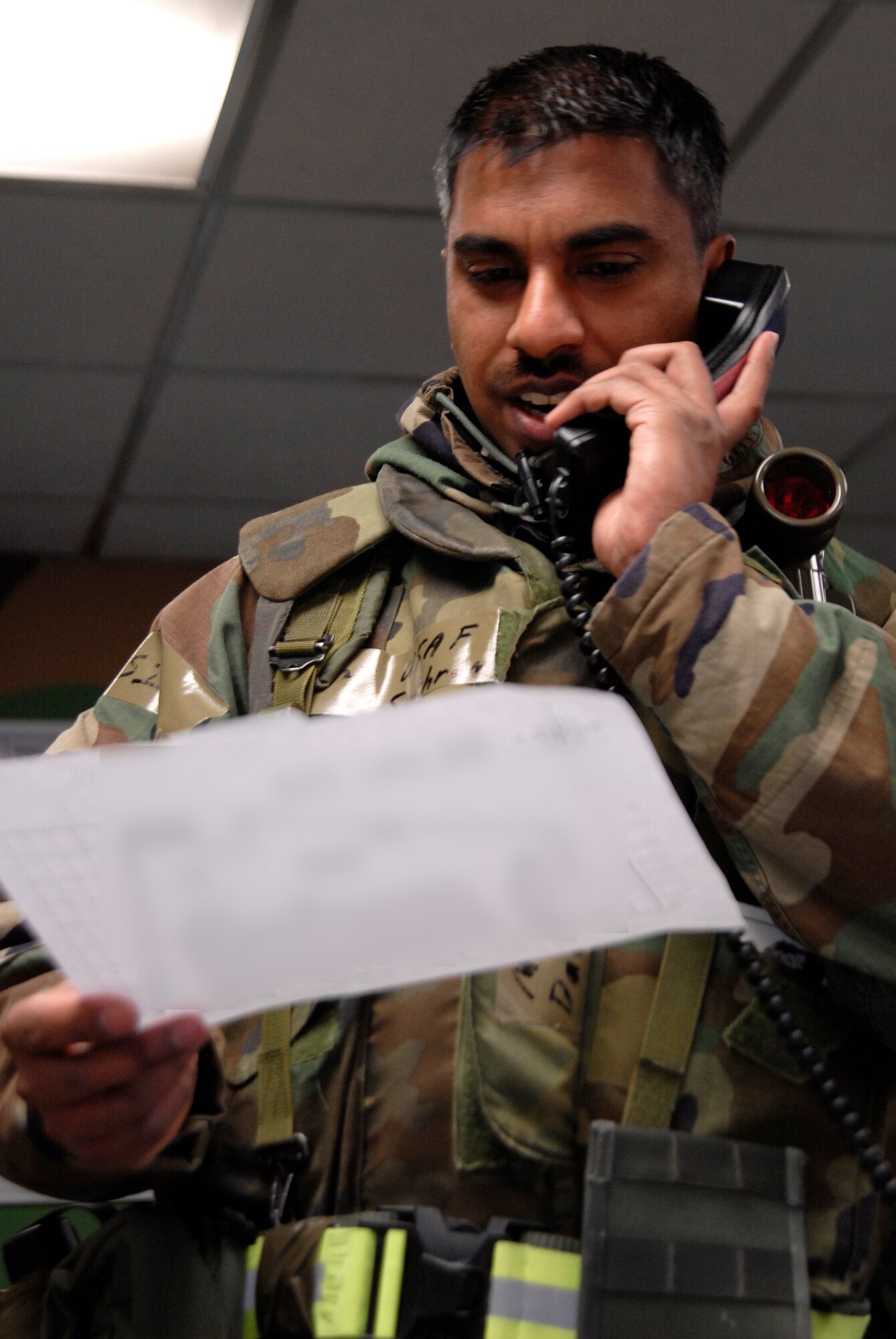 Master Sgt. David Sukhram, 8th Communication Squadron, gives one of his technicians directions to a location needing work while working in the Unit Control Center during the Peninsula Wide Operation Readiness Exercise at Kunsan Air Base, Republic of Korea, Jan. 14, 2009. (U.S. Air Force Photo by SSgt Jason Colbert)
