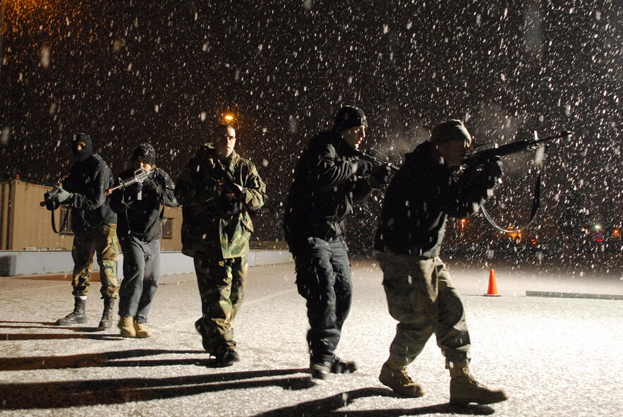 Opposing forces personnel move into a close file formation prior to conducting a raid on a portion of Osan AB, during Exercise Beverly Bulldog 09-01 Jan. 14. The 51st Fighter Wing is currently undergoing a week-long Operational Readiness Exercise to test its ability to conduct war time missions. The OPFOR personnel are comprised of Airmen assigned to Osan AB who volunteered to represent enemy personnel to assist with training purposes in different scenarios. (U.S. Air Force photo by Senior Airman Christopher Boitz)