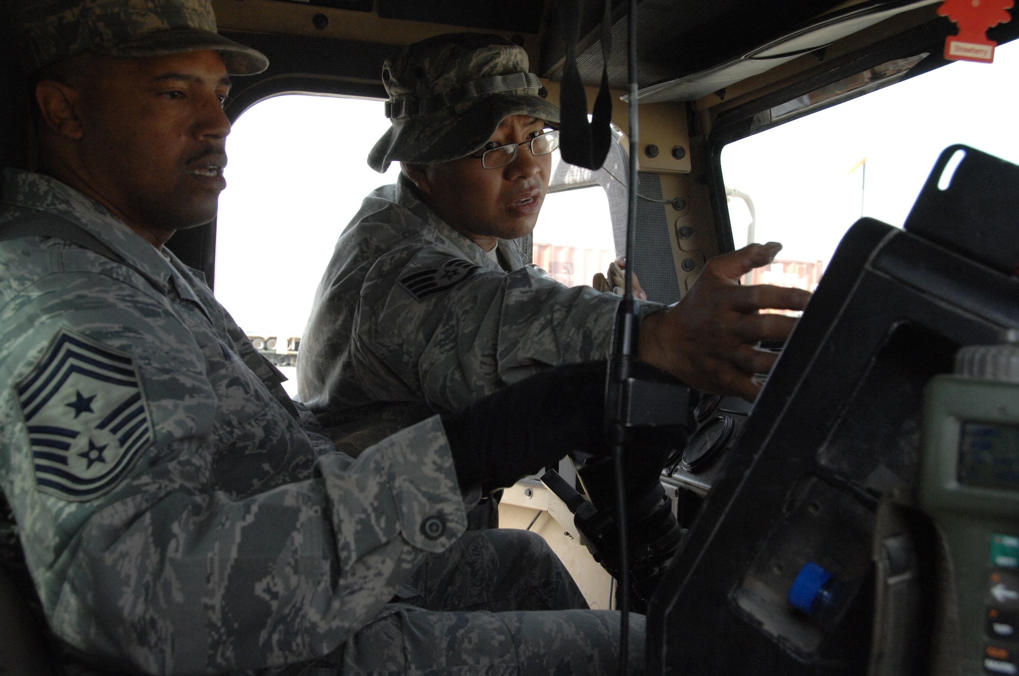 SOUTHWEST ASIA -- Staff Sergeant Alvin Santos, 70th Military Truck Detachment, explains different line haul truck operating controls to 386th Air Expeditionary Wing Command Chief Master Sergeant Jeffrey Antwine at an Army base in Southwest Asia, Jan. 11. All truck operators must complete refresher training before participating in a real-world convoy. (U.S. Air Force photo/Senior Airman Courtney Richardson)